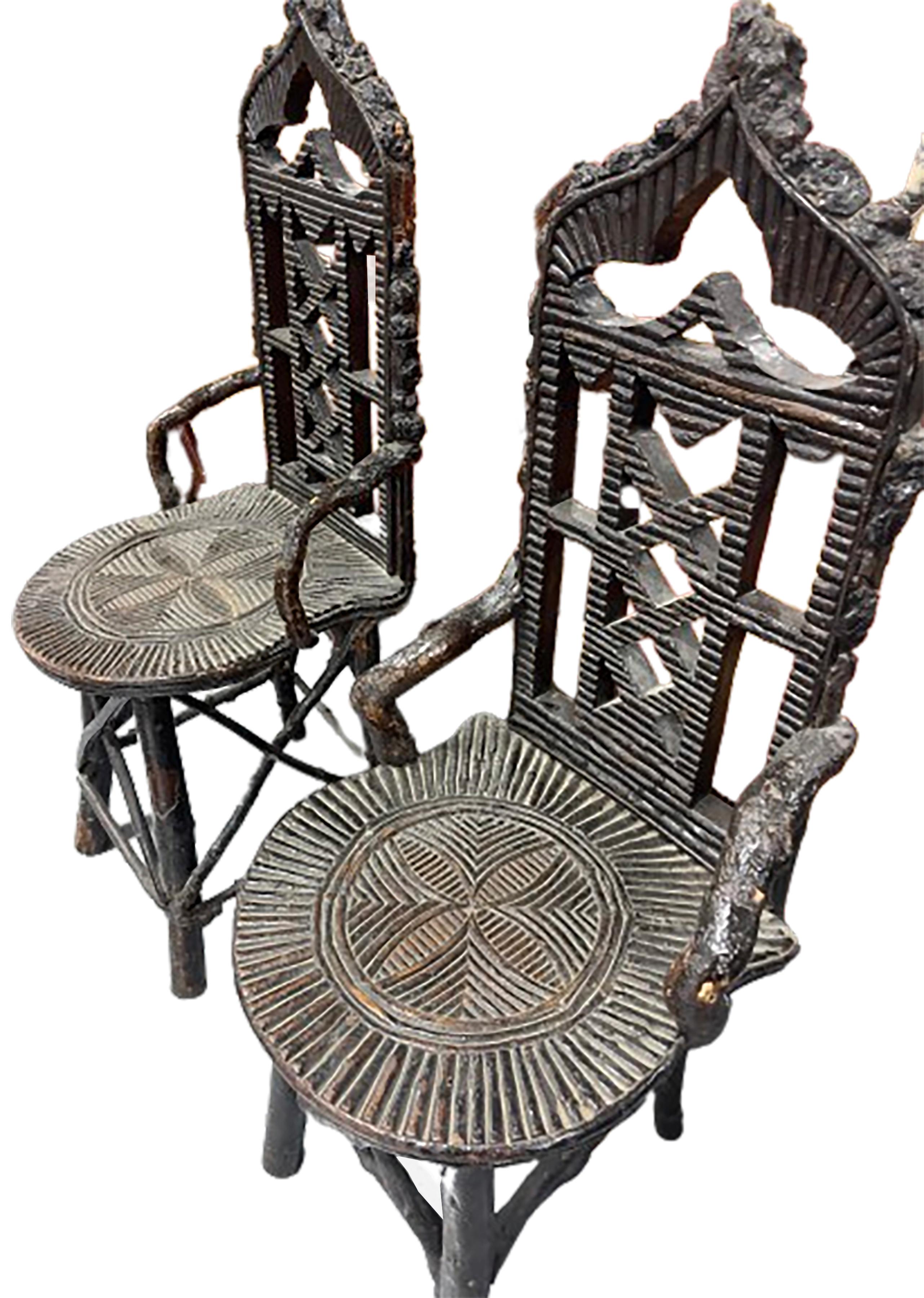 A handsome pair of primitive antique black forest chairs.  Intricately carved patterns on the seat as well as a ventilated back rest. Walnut. 
 
In good condition. Gentle wear consistent with age and use.  

This pair of chairs would make a great