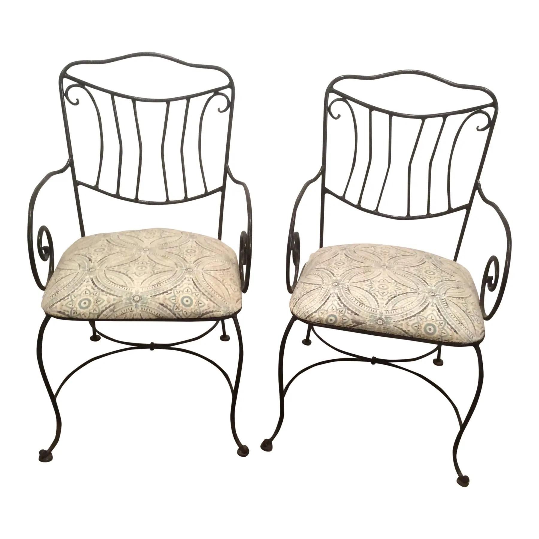 Pair of black wrought iron garden chairs with scrolling arm on cabriole legs and upholstered seat.
Upholstery is dirty and will need to be replaced.
