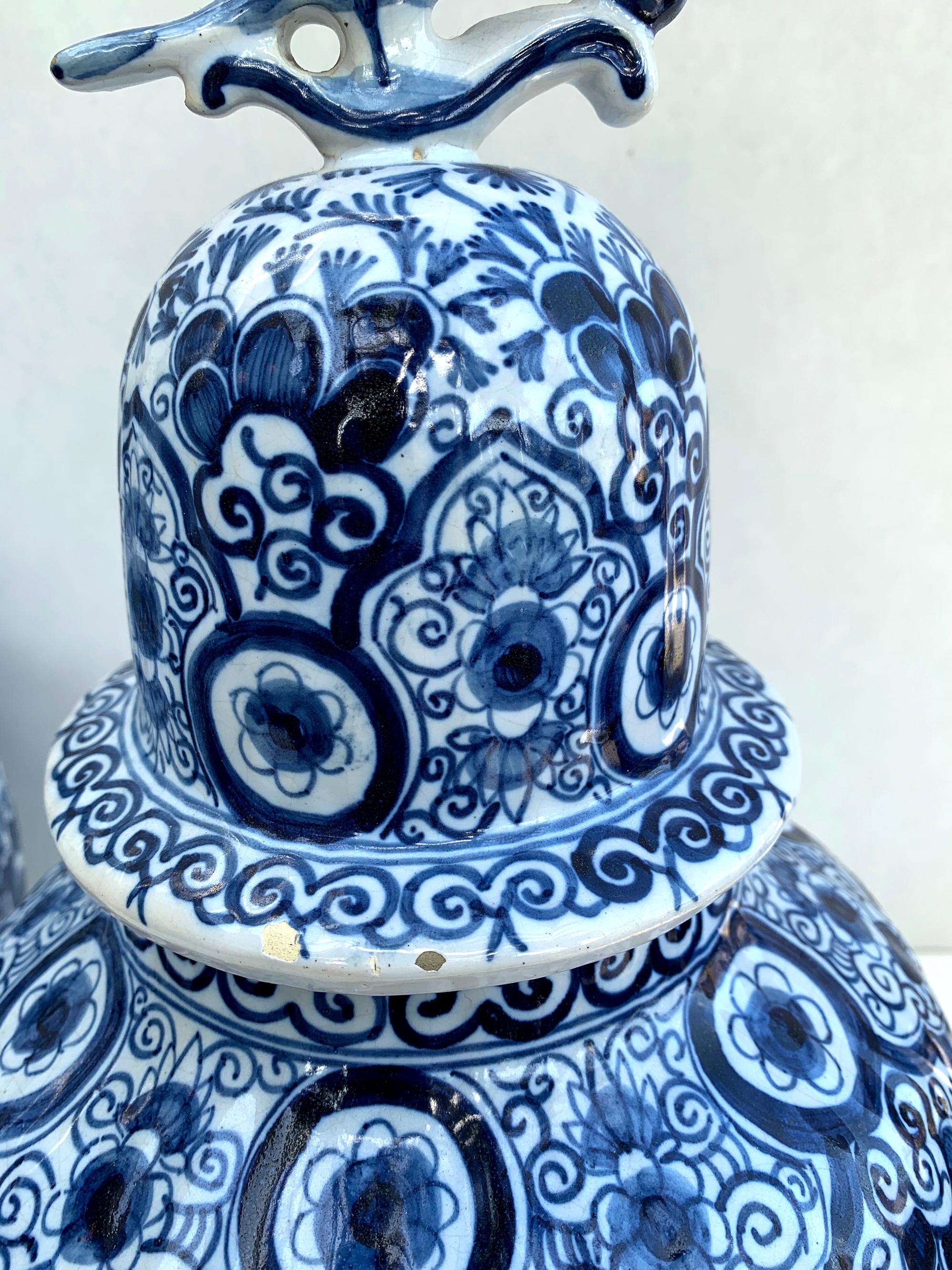 Rare large antique Delft blue and white lidded jars with bird finials. Marked AK on the bottom of each. Very good condition based on their marking age. Small chips on the bottom of one of the lid tops, and age wear throughout, see photos. These jars