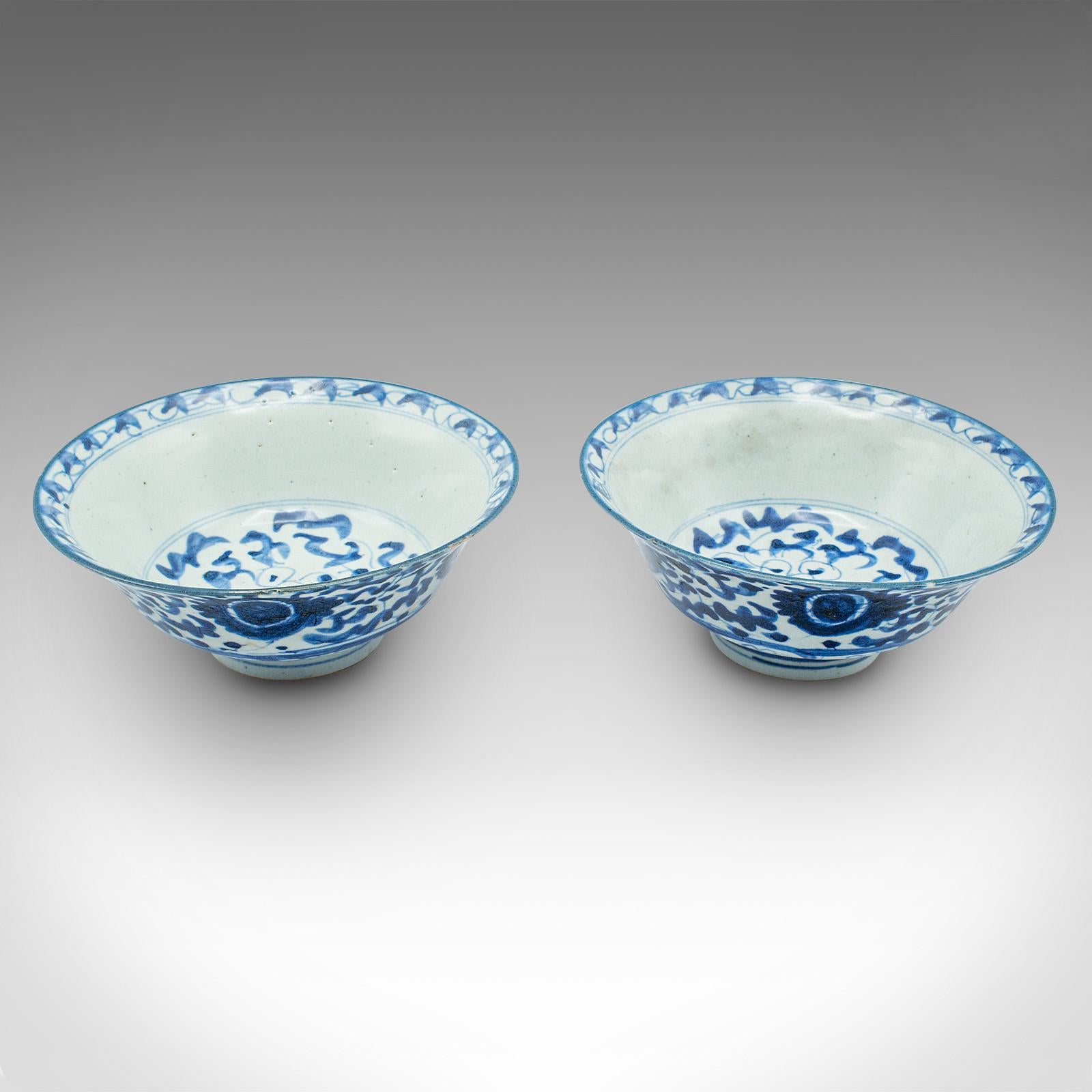 
This is a pair of antique blue and white serving bowls. A Chinese, ceramic decorative dish, dating to the late Victorian period, circa 1900.

Appealing Victorian blue and white pattern accentuates the bowl form
Displaying a desirable aged patina