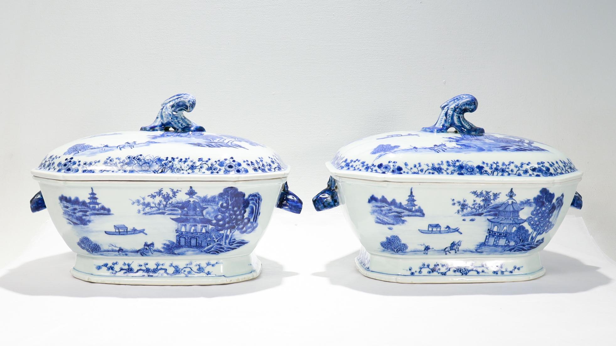 A fine pair of antique Chinese export porcelain covered tureens.

Each decorated in underglaze blue.

Both the body and the lid with a mountainous landscape scene with pagodas, trees, and a man in a boat. The borders and edges with floral devices.
