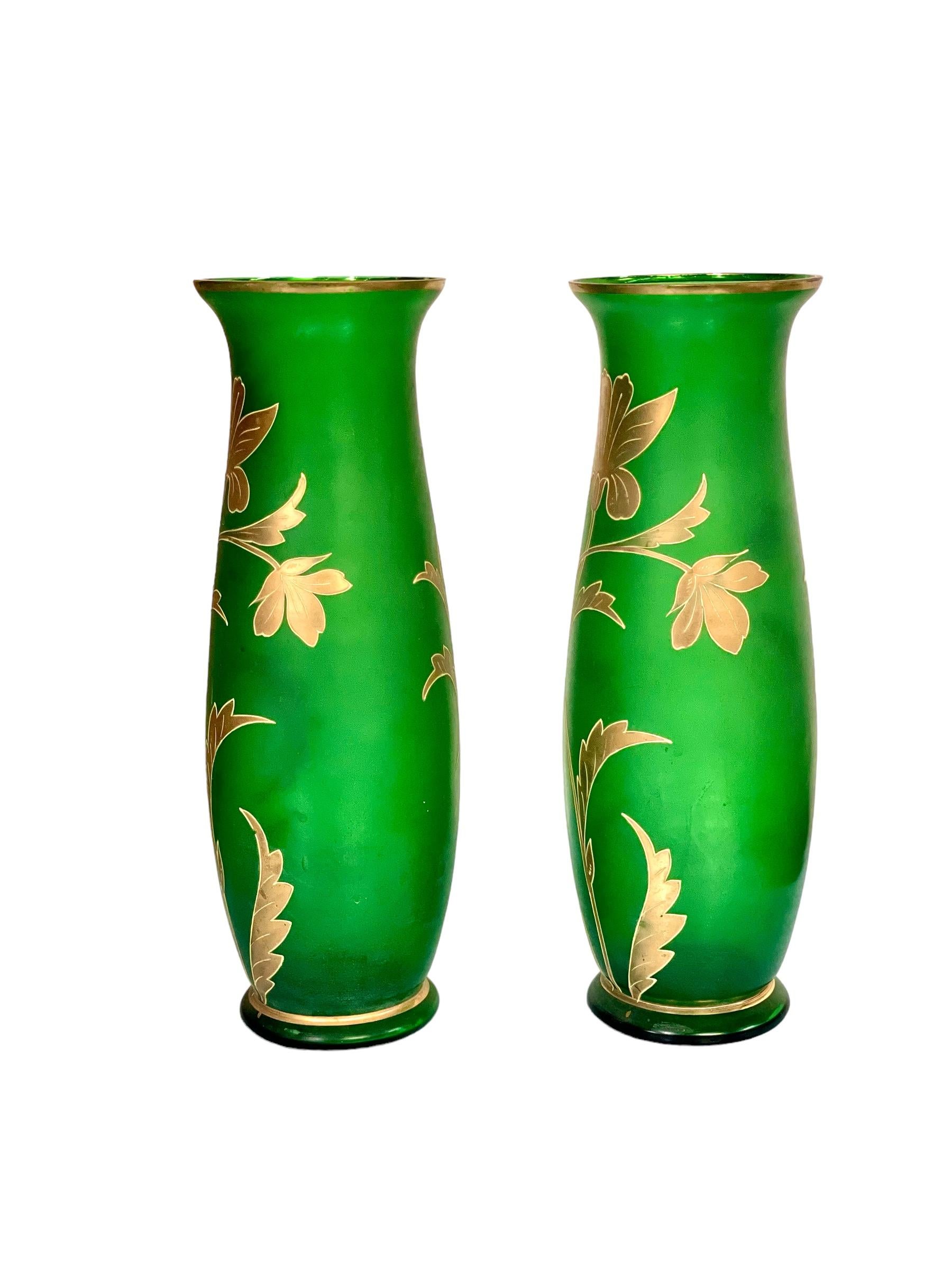A simply beautiful pair of tulip-shaped Bohemian glass vases in emerald green, in the Art Nouveau style. Dating from the end of the 19th Century, these stunning vases feature an uncomplicated design of spring flowers and foliage in applied enamel