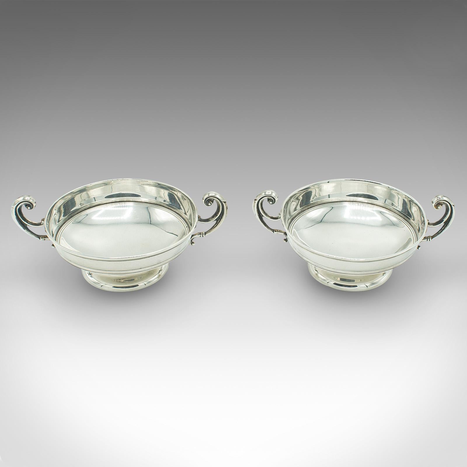 This is a pair of antique bonbon dishes. An English, sterling silver serving bowl, dating to the Edwardian period, hallmarked in 1909.

Elegant and petite, ideal for the sideboard or mantlepiece
Displaying a desirable aged patina and in good