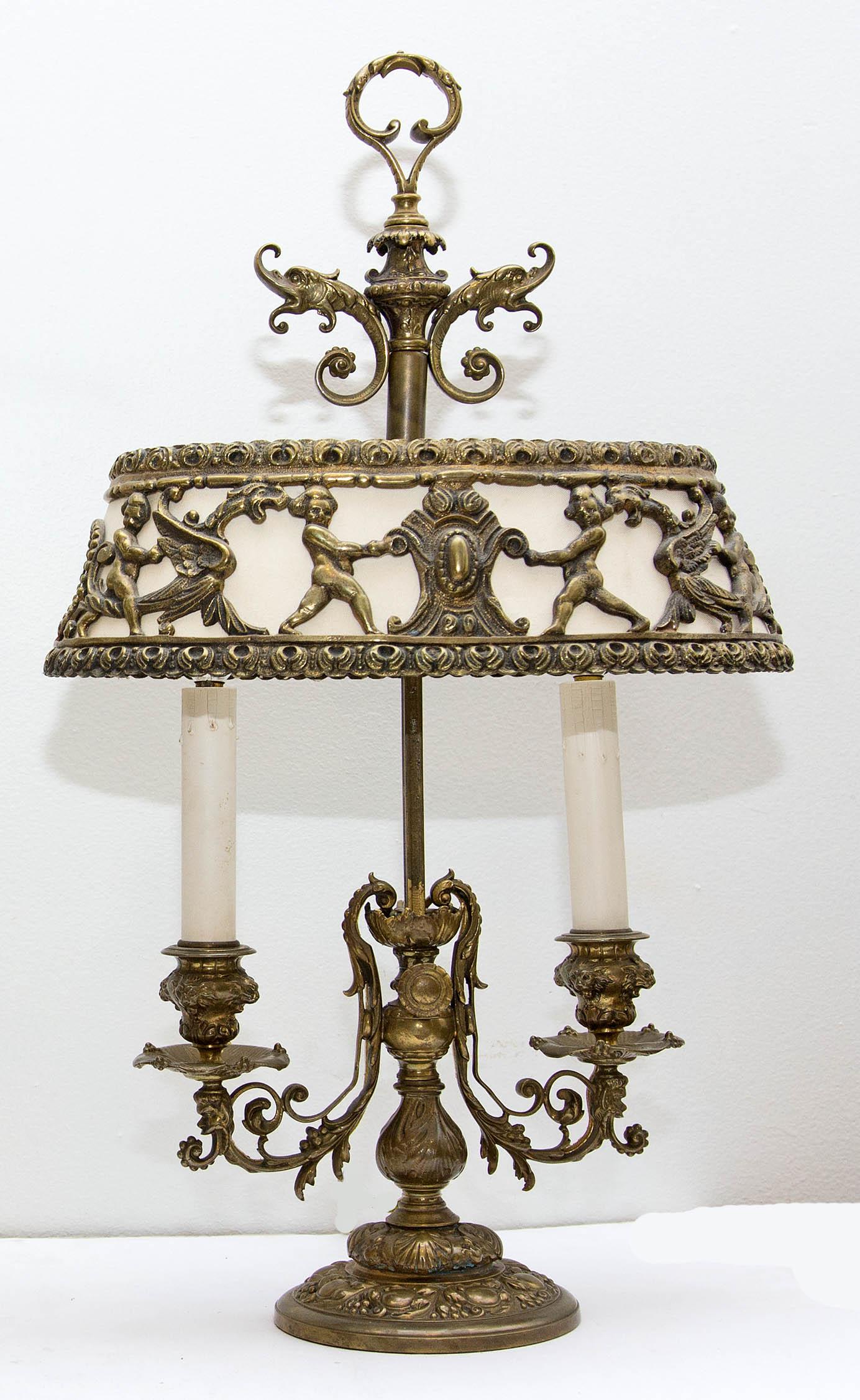 Pair of Renaissance Revival style brass Bouillotte table lamps. Brass and fabric shades, circa 1920s.