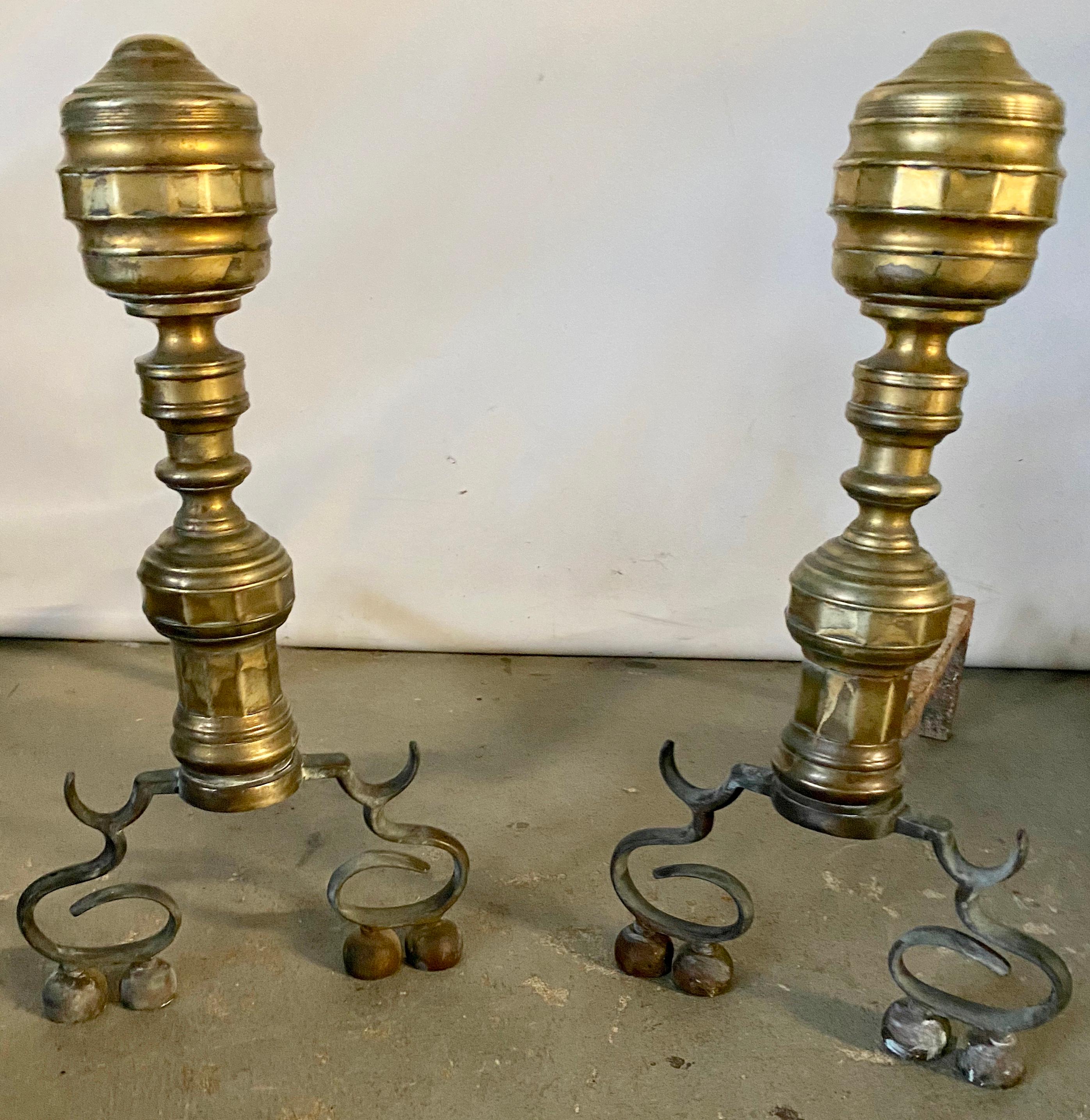 A Classic pair of Empire style antique brass andirons with aged patina. Wonderfully handsome, will add style and character to any fireplace. OAL 17L.