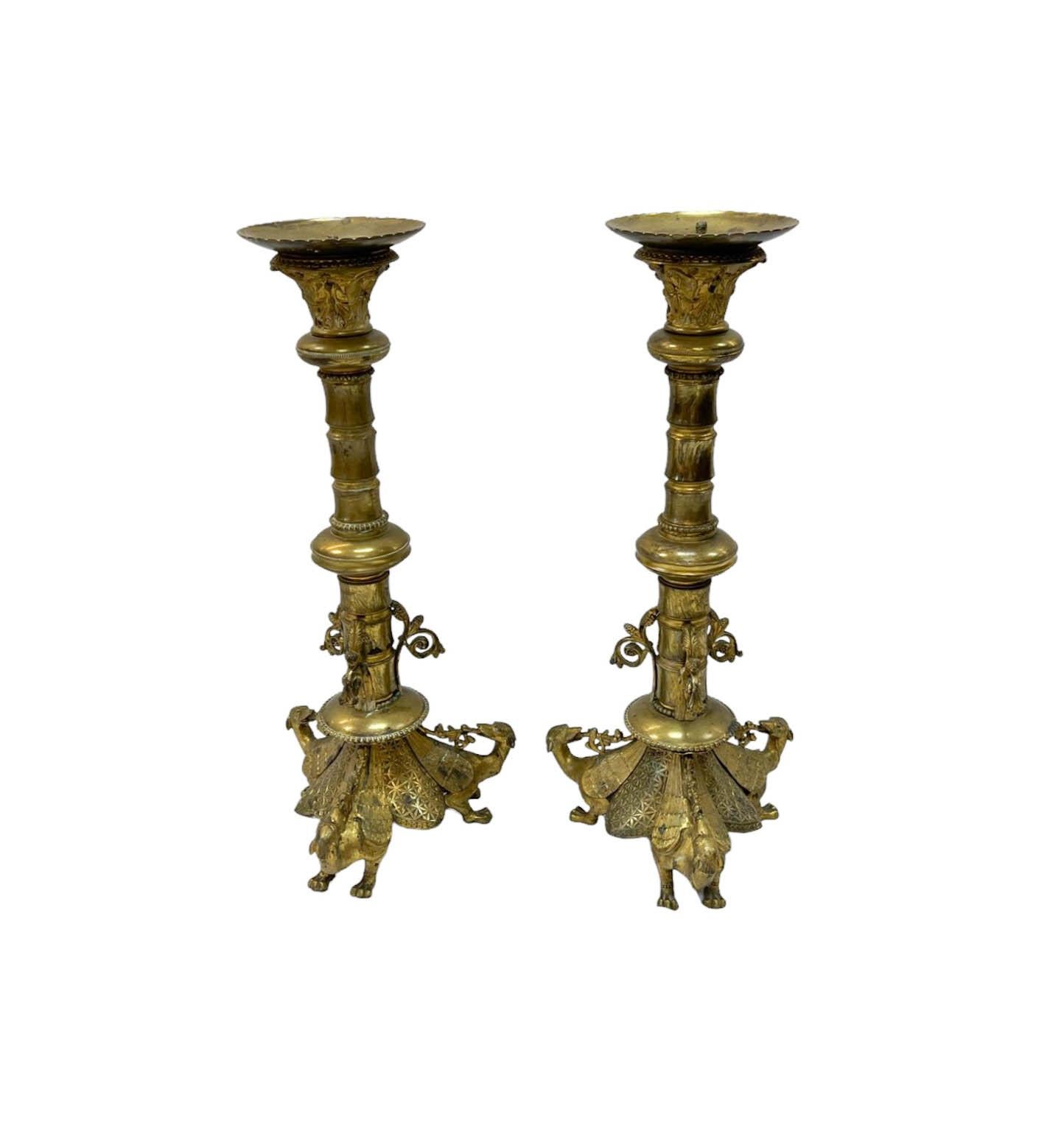 Pair of large antique brass candle holders. The iconography depicting the winged dog/lion can be traced back to the East Slavic tradition of mythological creatures. 