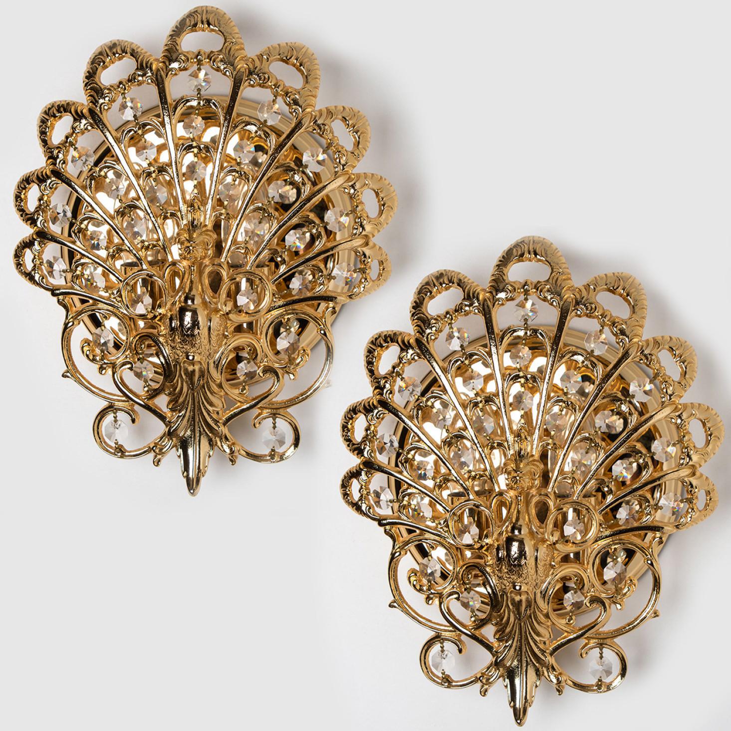 Pair of beautiful brass wall lights with crystal glass beads. Manufactured in the 1960s in Europe, Spain.

The lights are in the  shape of a peacock. With crystal beads between the brass feathers.

They illuminate beautifully.

Measurements: depth
