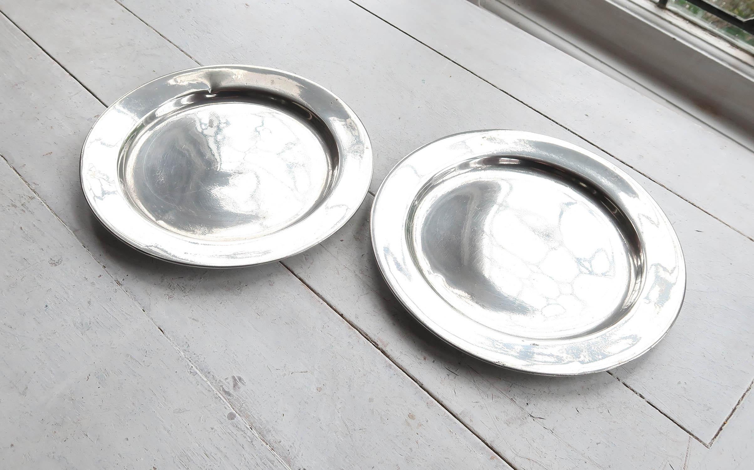 Lovely pair of highly polished pewter plates.

The pewter has been polished to its original shine to imitate polished silver. It was known as the Poor Man's Silver.

The great thing about polished pewter is that it will retain its shine unlike