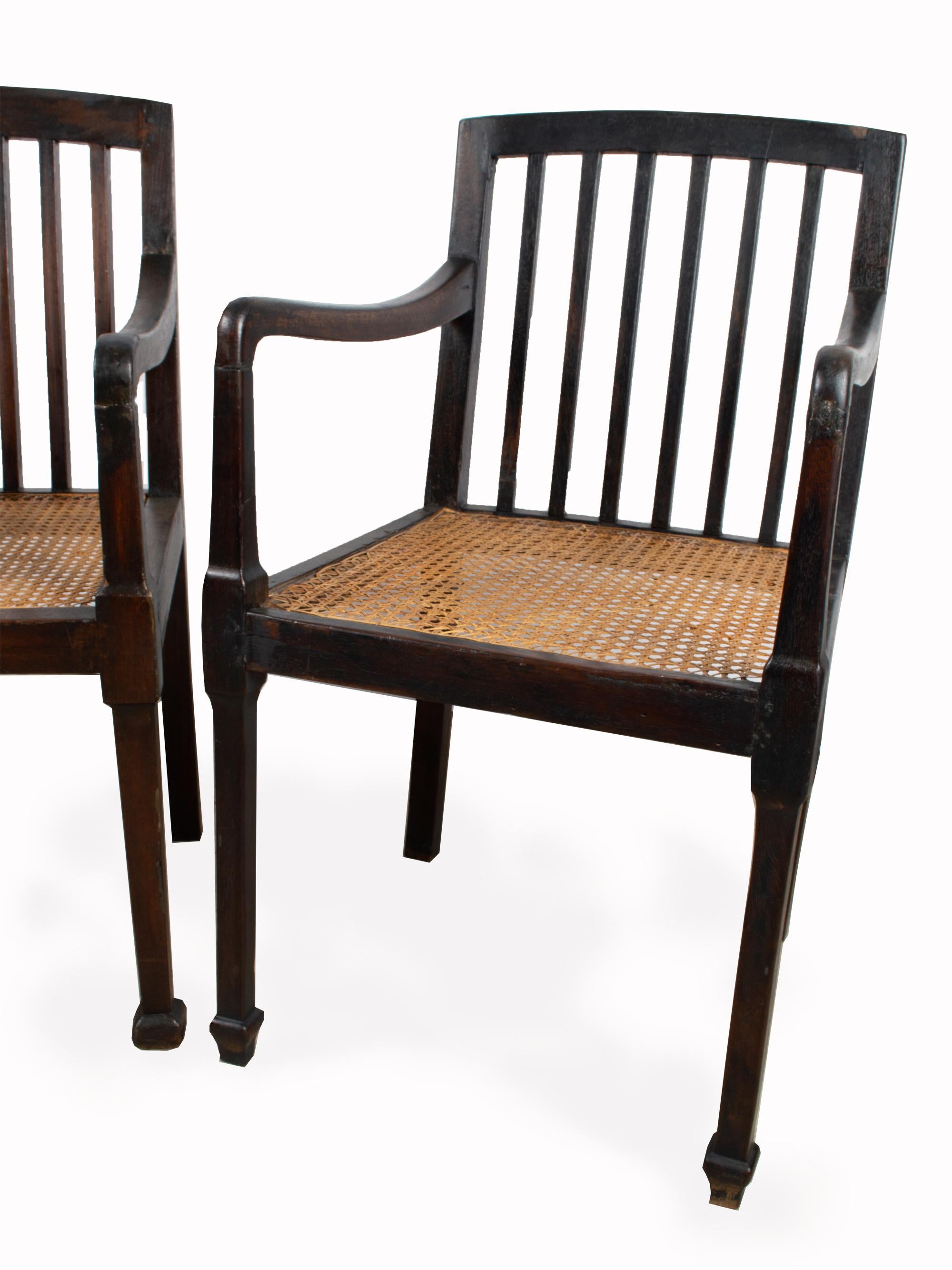 Pair of Antique British Colonial Teak and Rattan Hall Elbow Chairs