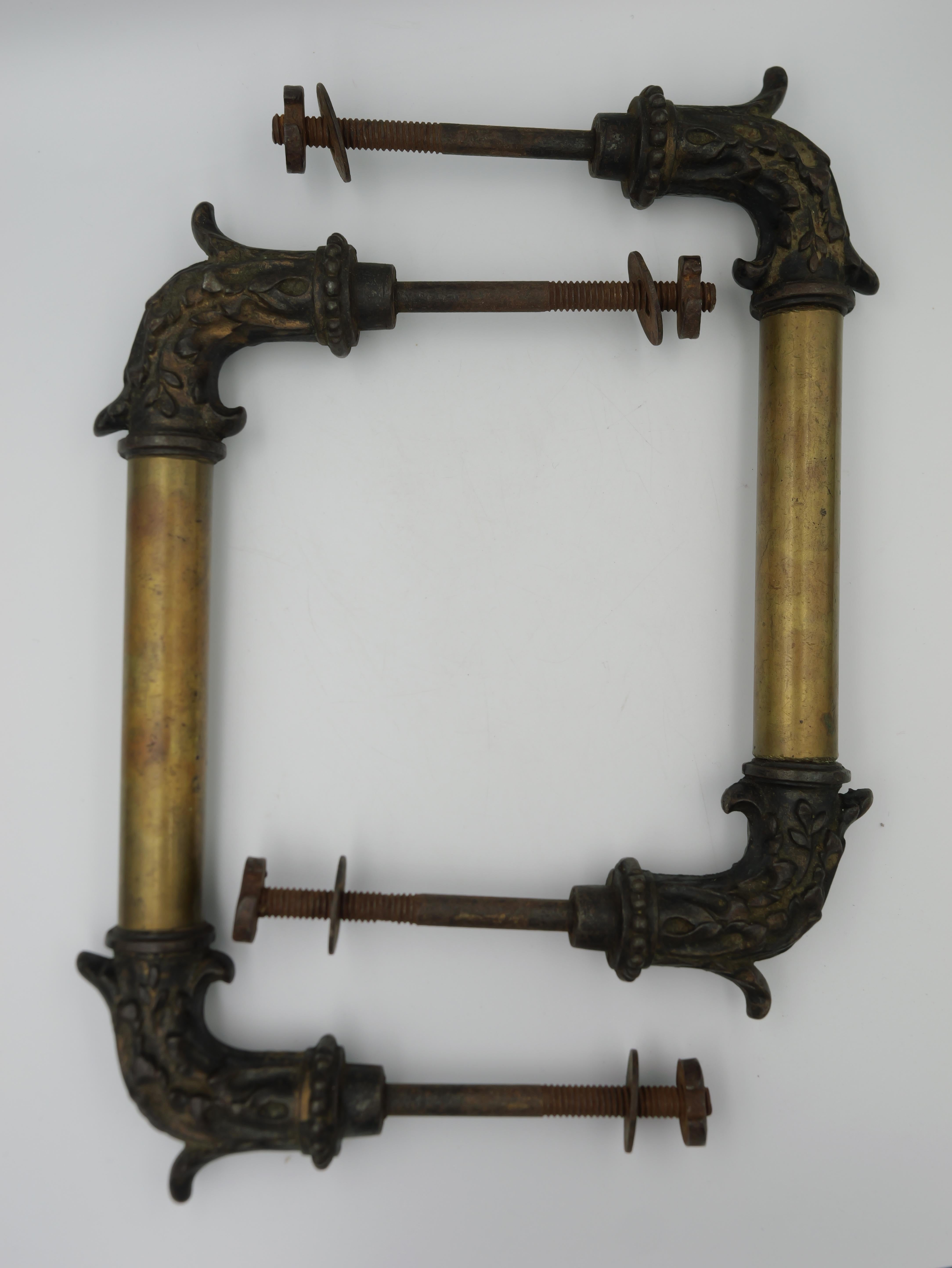 This pair of antique bronze and copper door handles is a remarkable testament to the beauty and craftsmanship of a bygone era. These exquisite handles, crafted from a combination of bronze and copper, exude a timeless elegance that enhances the