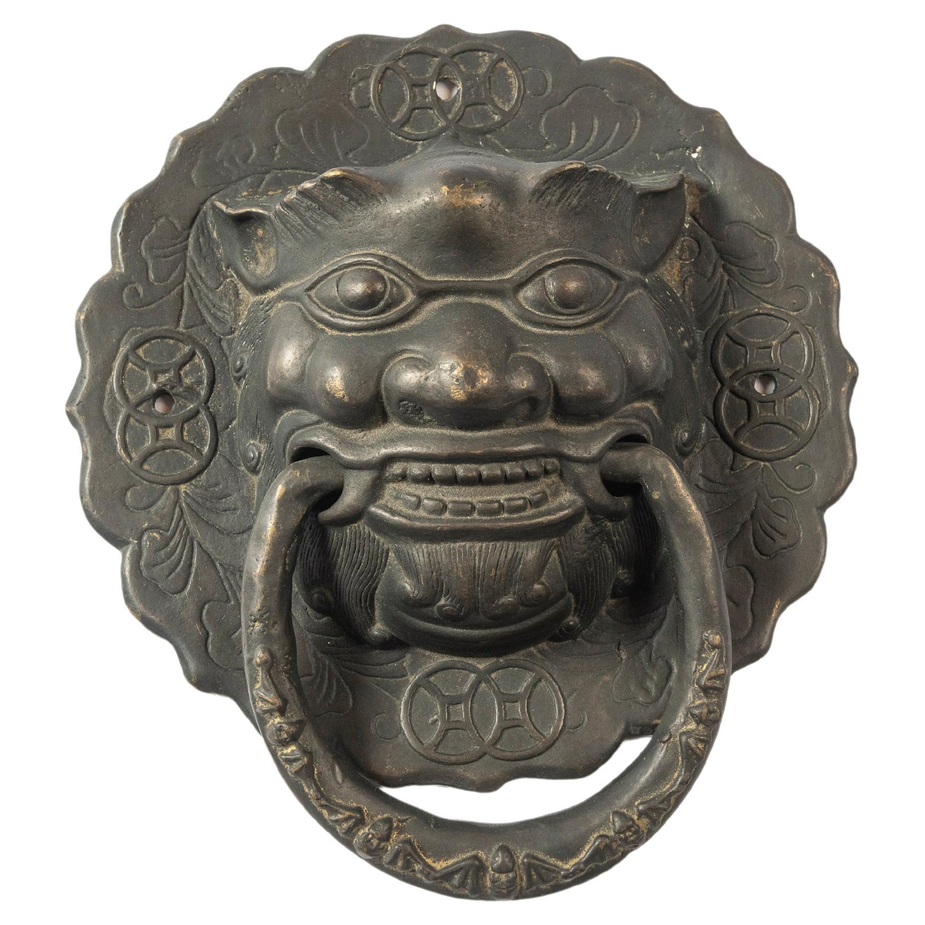 Chinese Foo Dogs are symbolic, protective statues, designed and sold in pairs. This enduring antique set hangs beautifully on a pair of doors, either functionally or as decor, and are a good size to make a statement. The patina is beautiful and