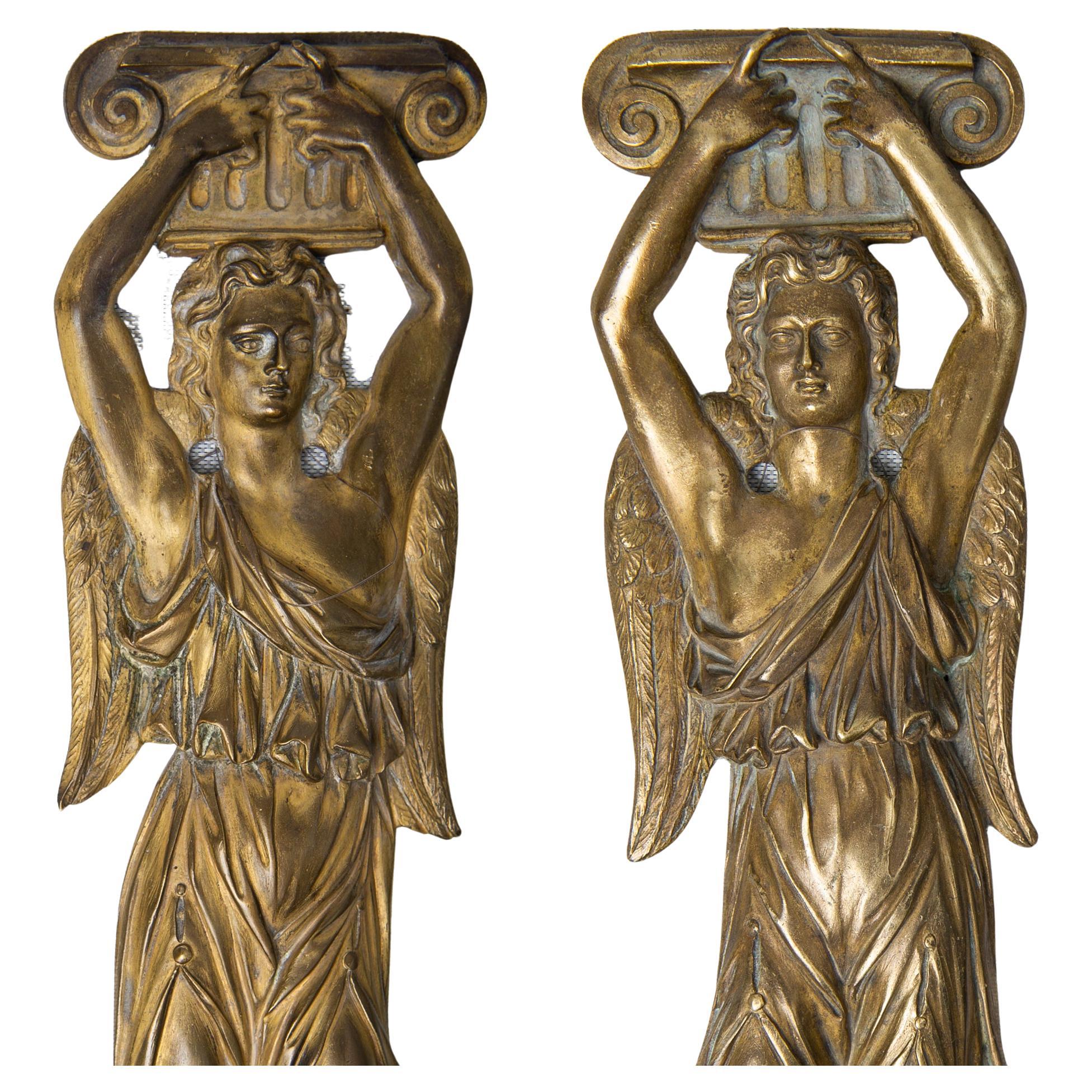 Rare pair of antique bronze friezes, from some large antique furniture, may be even from a bookcase: in fact I would put them on the uprights of a bookcase.
But if You hang them under a fabric fan, they become two appliques (wall lamps).
 
