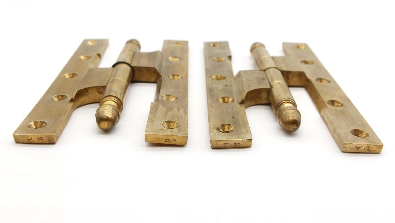 Antique 20th century polished cast bronze left paumelle door hinges featuring ball tips at both ends. Also a template hole pattern with four knuckles. Measures: 8 in. x 4 in. Small quantity available at time of posting. Priced each. Please inquire.