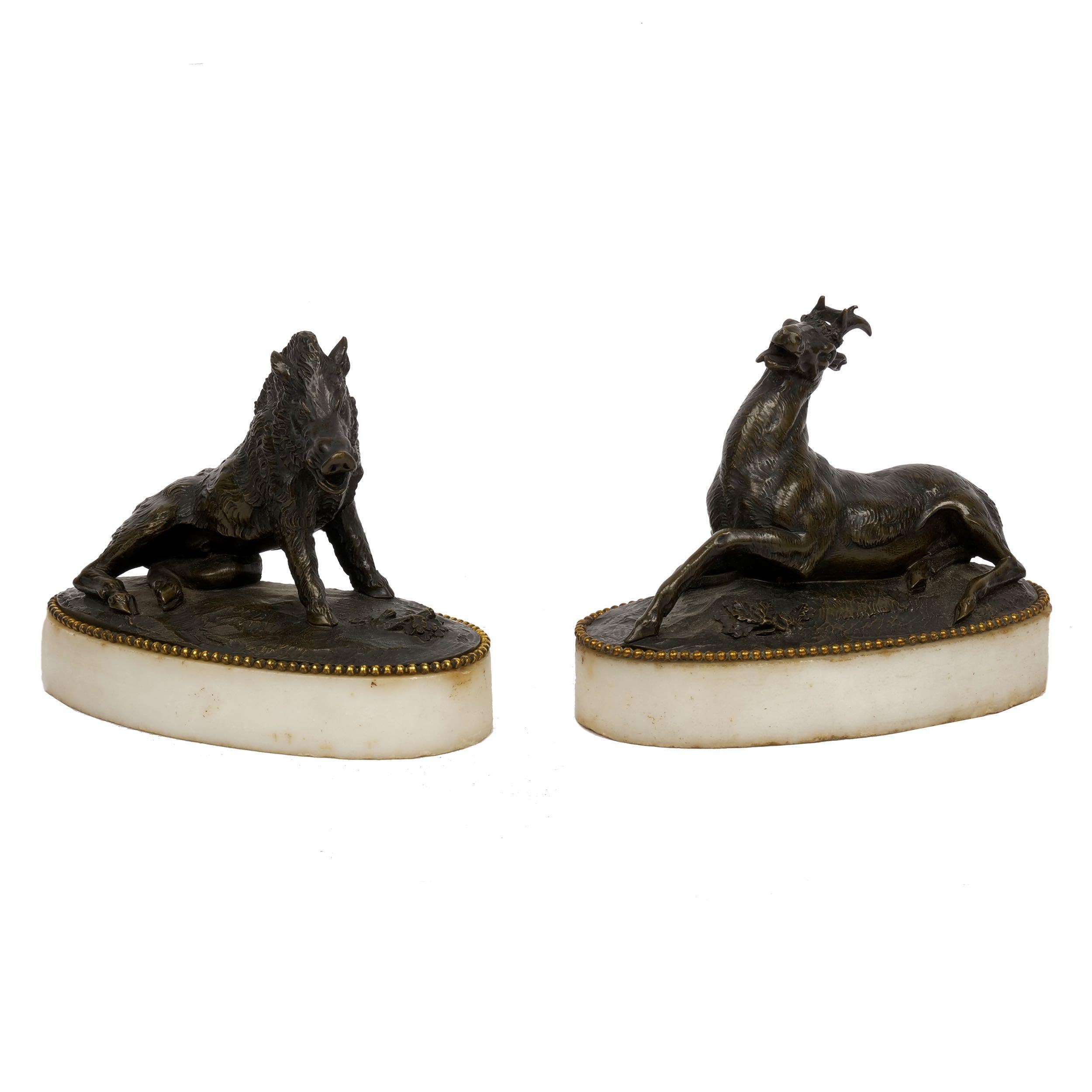 Pair of figural bronze paperweights over cararra marble bases.
circa early 19th century; models of 
