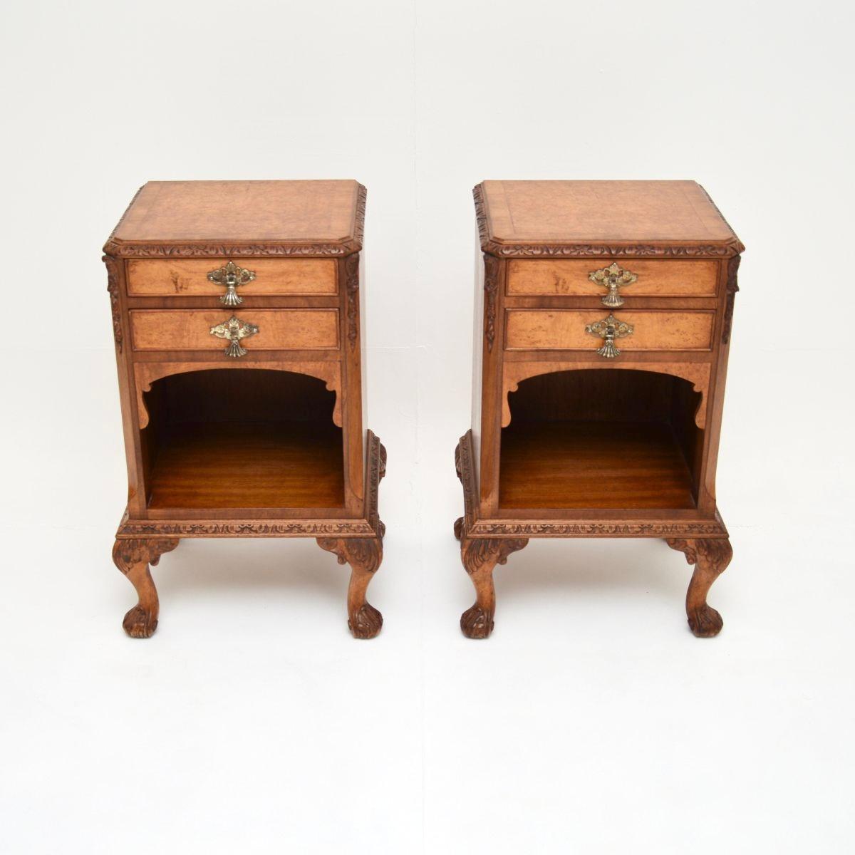 A gorgeous pair of antique burr walnut bedside cabinets. They are in the Queen Anne style, they date from the 1920-30’s.

The quality is exceptional, they have stunning burr walnut grain patterns and crisp carving throughout. The tops are cross