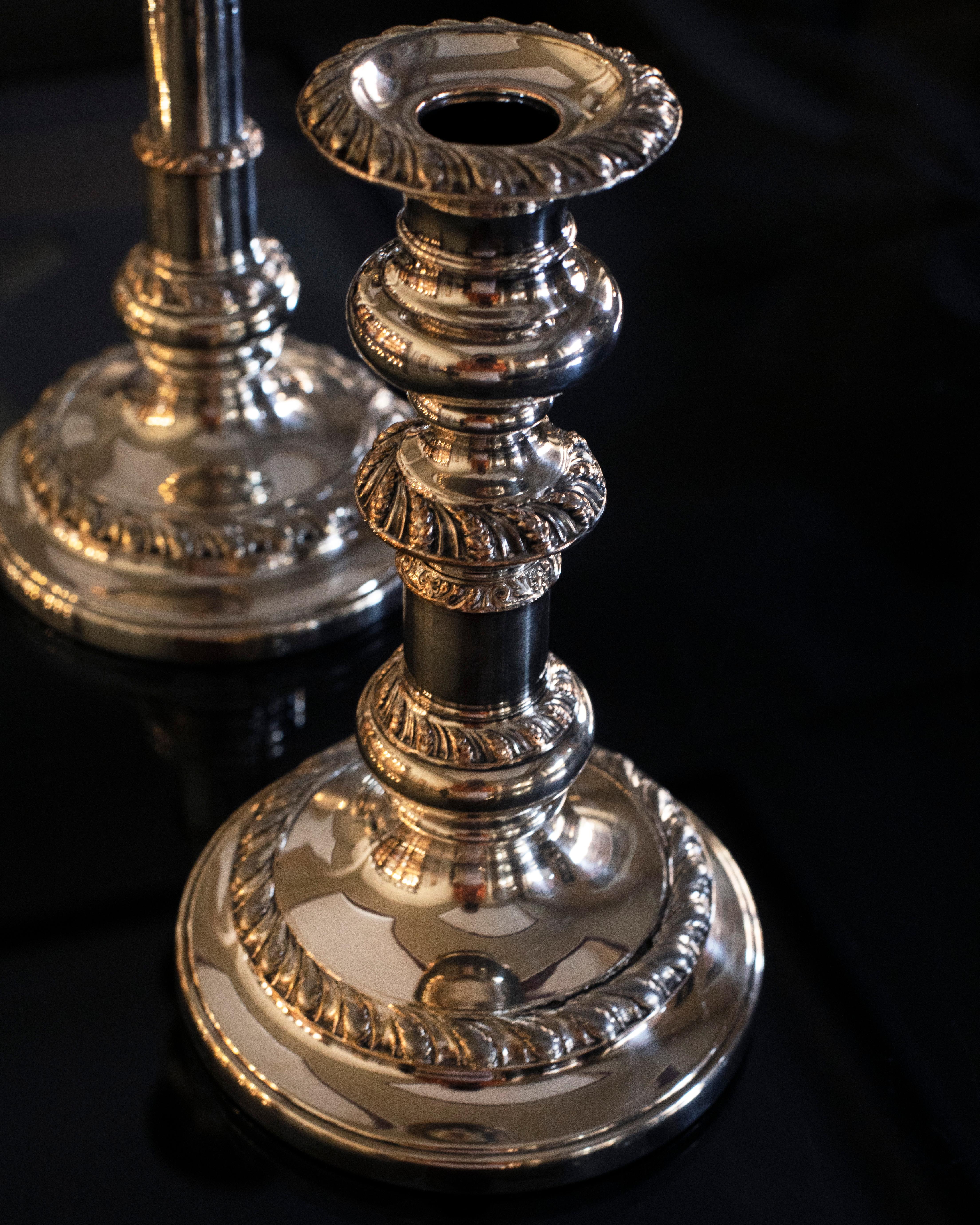 An English, old Sheffield decorative candle holders, dating to the late Victorian period, circa 1890. Appealing late Victorian pair with fine detail and elegant craftsmanship. The unique mechanism, also known as 