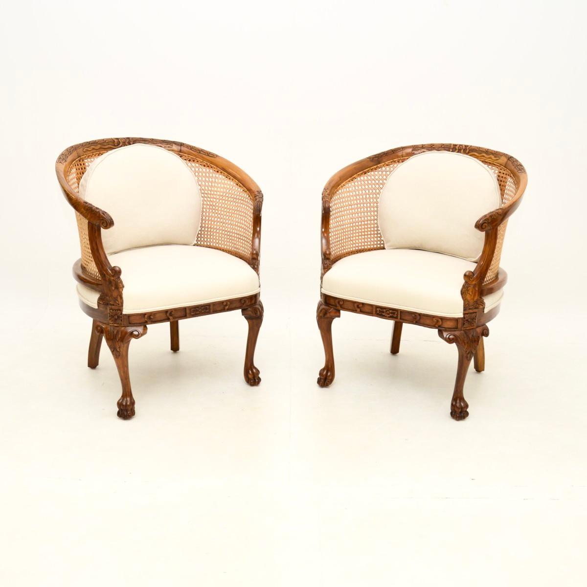 A beautiful pair of antique caned walnut bergère armchairs. They were made in England in the Queen Anne style, they date from around the 1920’s.

The quality is exceptional, with finely detailed carving throughout. The wood has a gorgeous colour