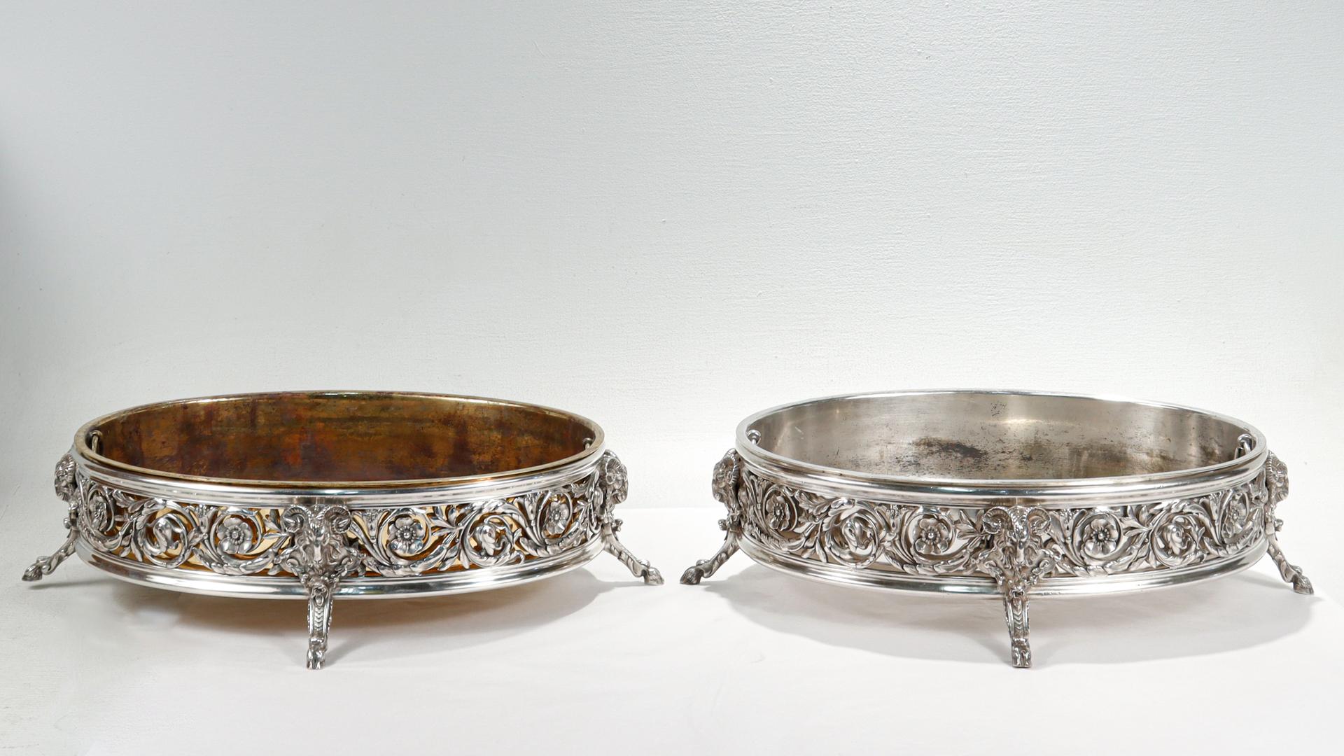 A fine pair of antique French centerpieces or serving bowls.

By Cardeilhac.

In silvered bronze.

Each with cast floral decoration around the circumference supported by detailed ram's heads leg with hoof feet.

With one gold plated & one silver
