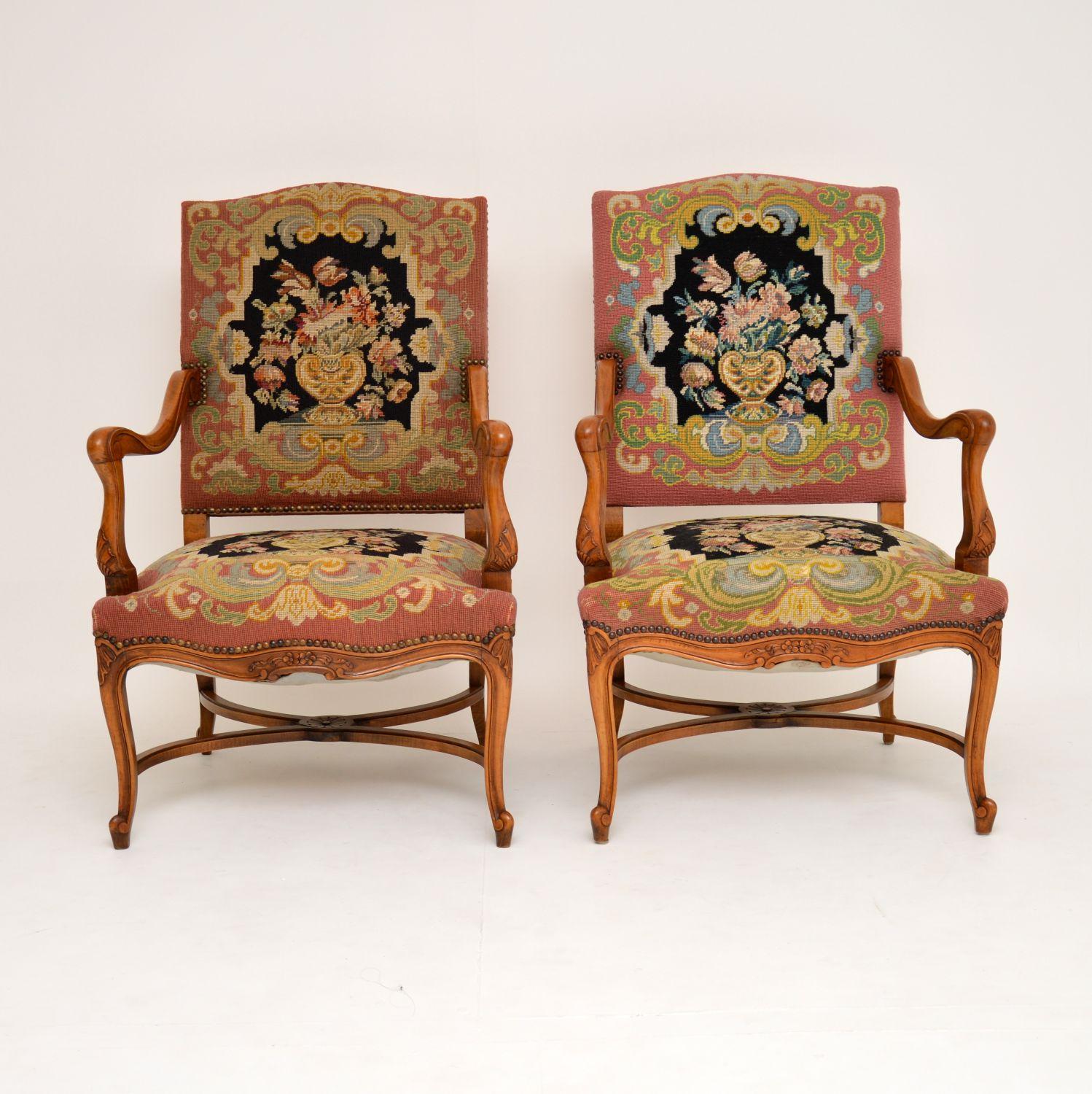 This pair of antique open armchairs have the original needlepoint fabric which is still in excellent condition and very colorful too. We just brought these over from Sweden, so presume they are Swedish, although there are brass engraved plaques on