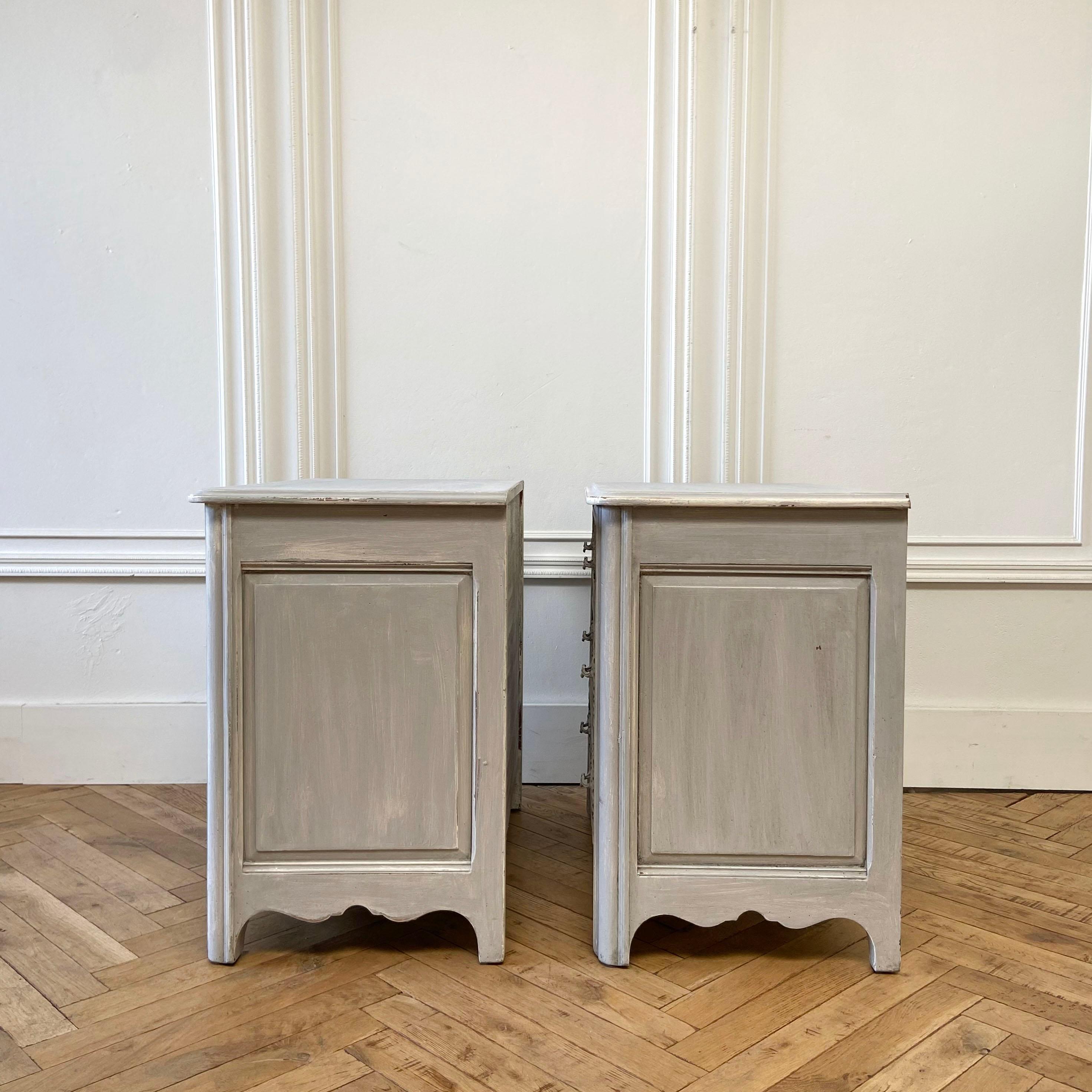 Pair of antique carved and painted French 3 drawer chests or night stands.
Painted in a Gustavian gray paint with subtle distressed edges, and antique glazed patina.
These 3 drawer chests have a solid wood dovetail construction.
Drawers open and