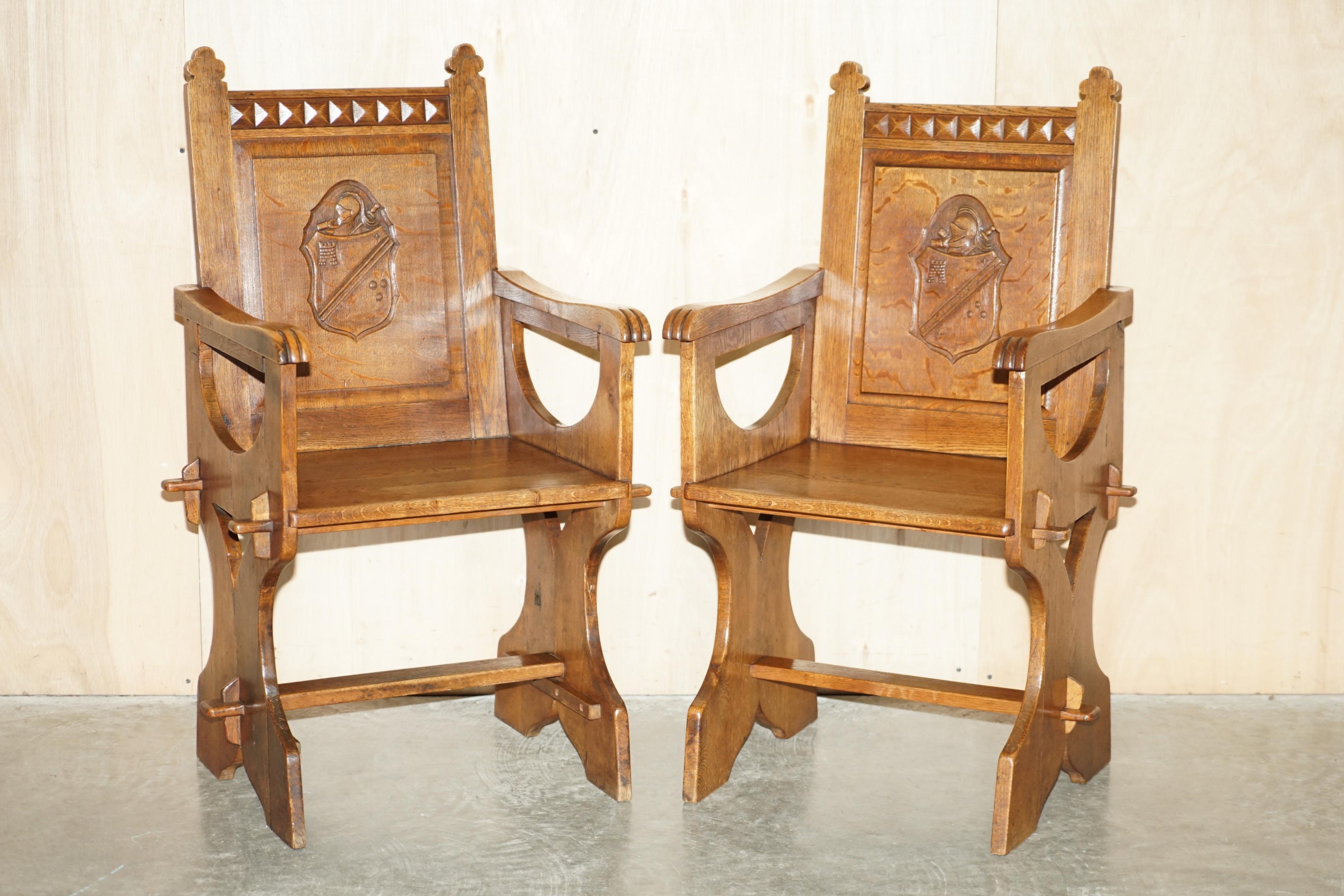 We are delighted to offer for sale this stunning pair of antique English oak hand carved chairs with Armorial coat of arms to the backrests 

A good early original pair, hand carved, nicely executed, they are rare to find with armorial coats of