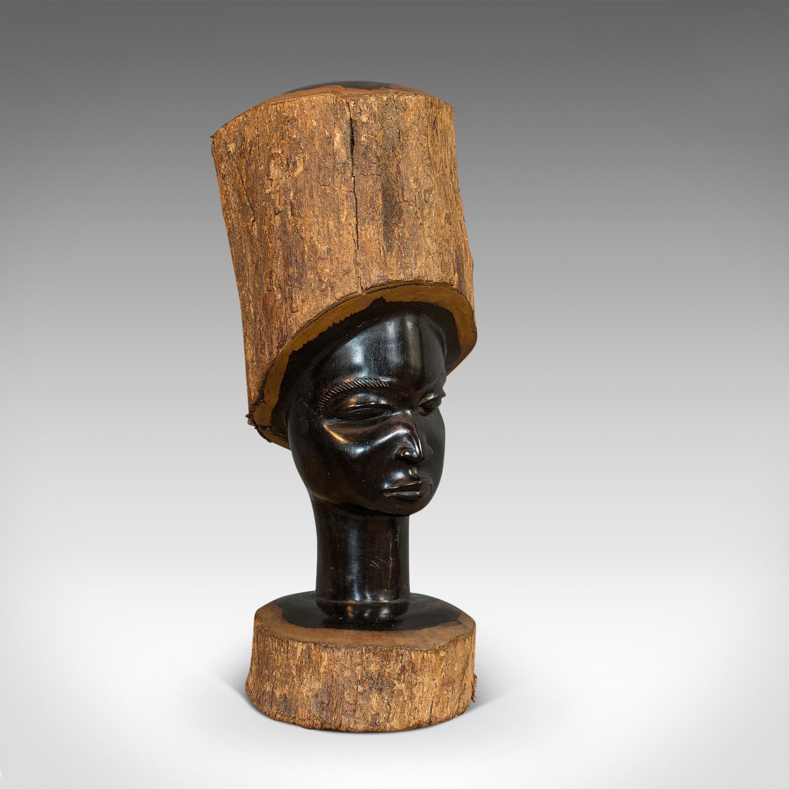 This is a pair of antique carved heads. An African, solid ebony decorative statue, dating to the late Victorian period, circa 1900.

Highly appealing Folk Art
Displays a desirable aged patina
Ebony stocks with carved, polished centers

Natural
