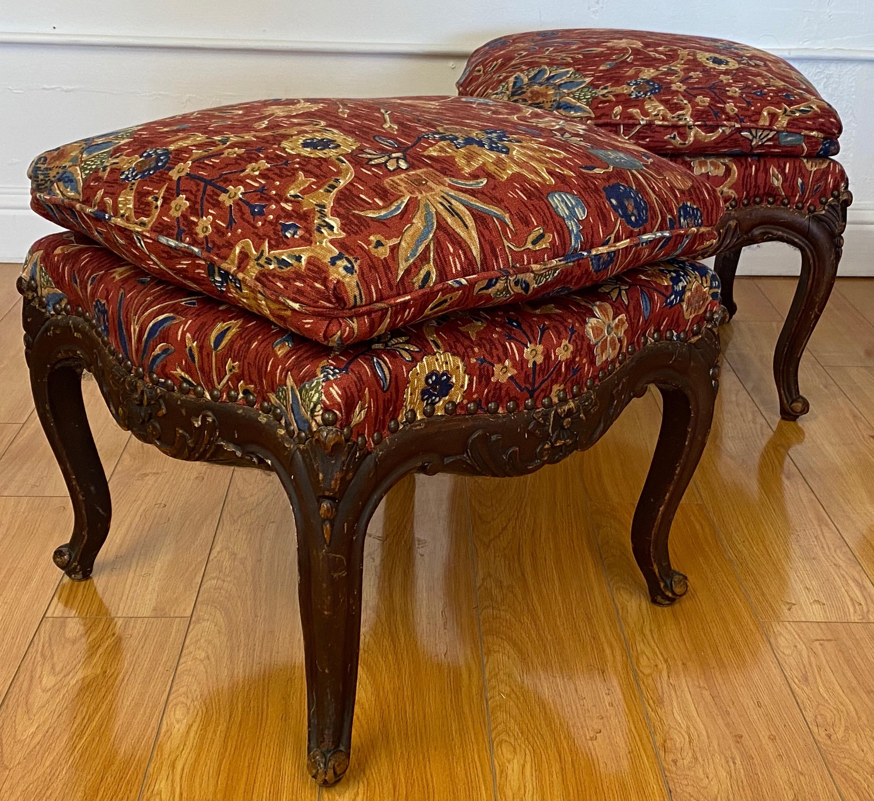 Pair of antique carved mahogany framed benches

The frames are late 19th-early 20th century

The fabric is late 20th century

Each seat measures 19