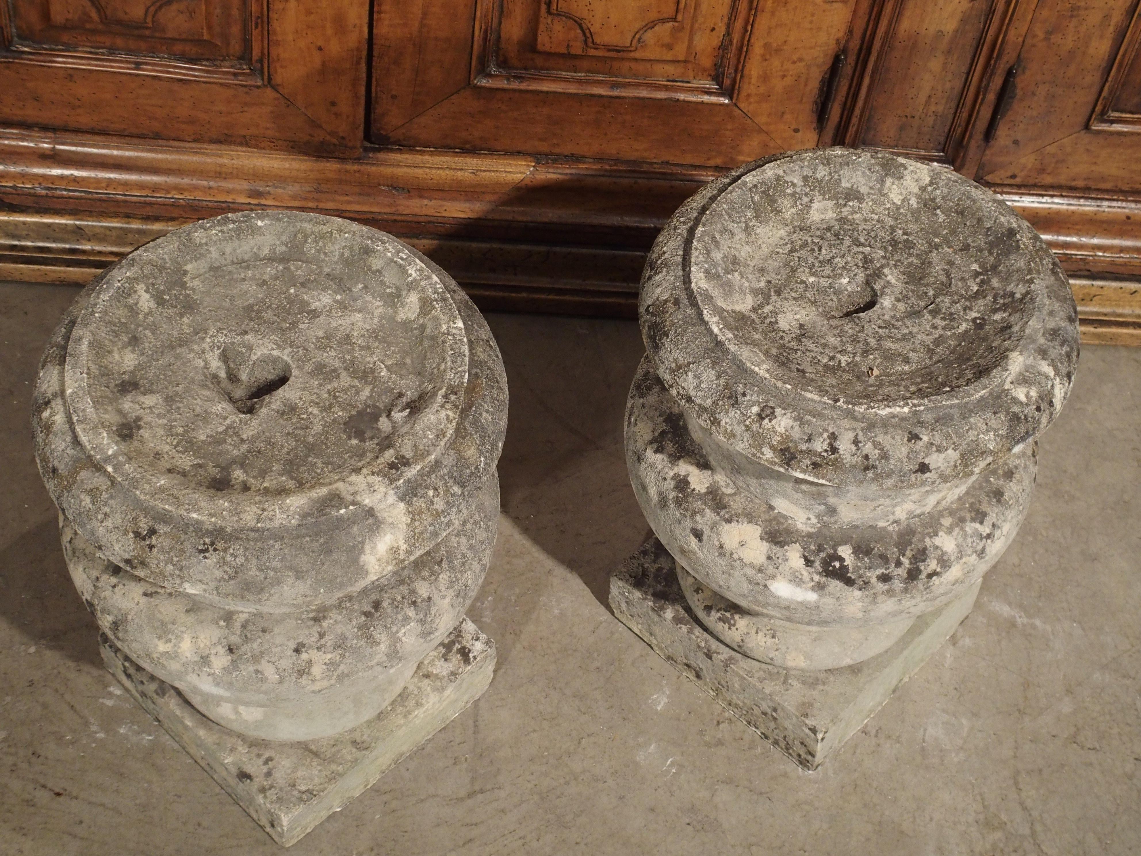 This wonderful pair of antique hand carved urn shaped finials came from a property near Bordeaux, France (second pair available, please inquire if interested). Each has some sort of small mounting hole on the top, which might have held an iron