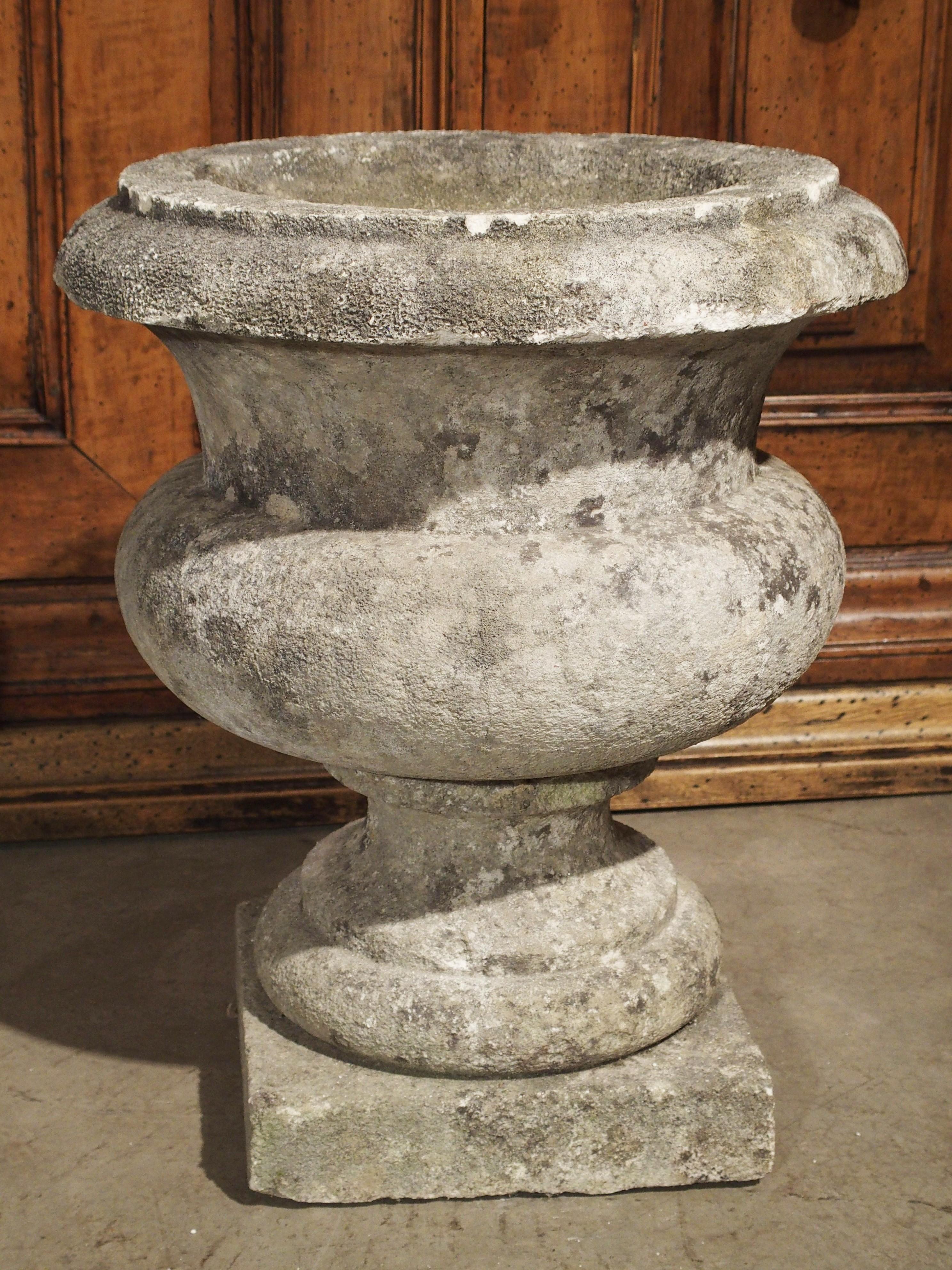 These classic antique carved stone garden vases are from a property in Bordeaux, France and date to the 19th Century (we have a second pair (finials) available, please inquire). They are indented at their waist with round bases which rest upon