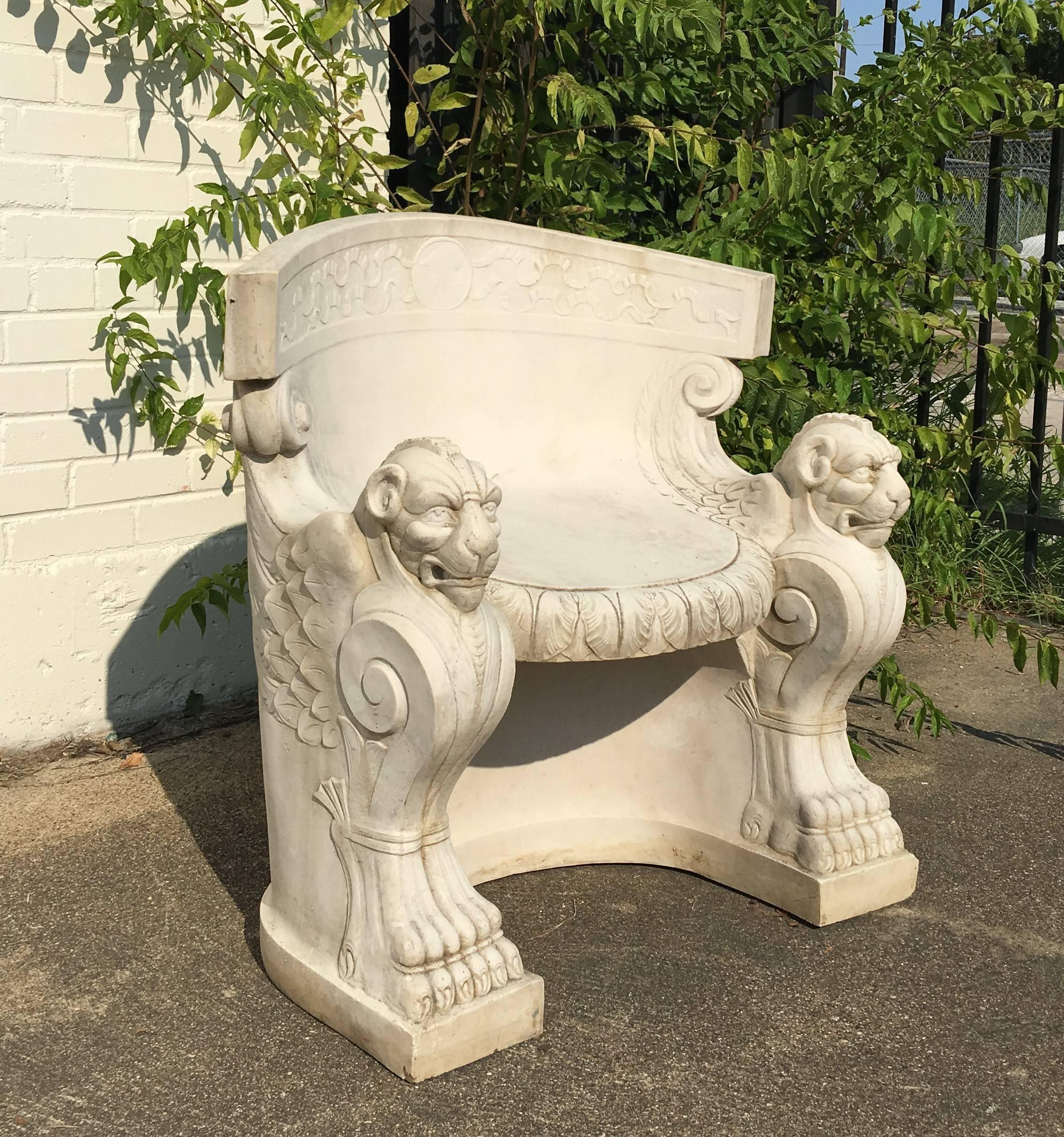 Very impressive pair of antique carved white composition stone throne/garden chairs. Each chair featuring a curved back extending to scrolled arms with winged lion head terminal hand holds. Joined to shaped and molded seat with conforming apron; the