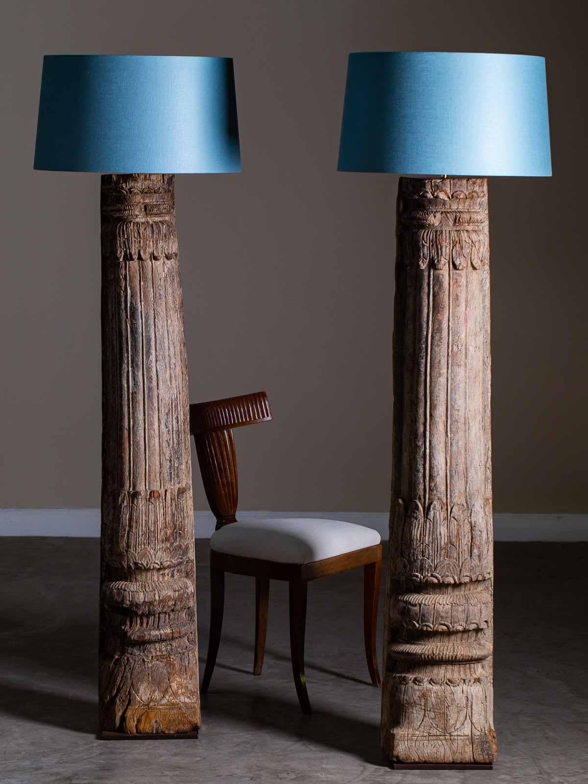 This pair of antique Indonesian floor lamps circa 1890 have the most marvellous carved surface that shows the passage of time. Originally from a structure built in the 19th century these pillar post column supports were liberated when the building