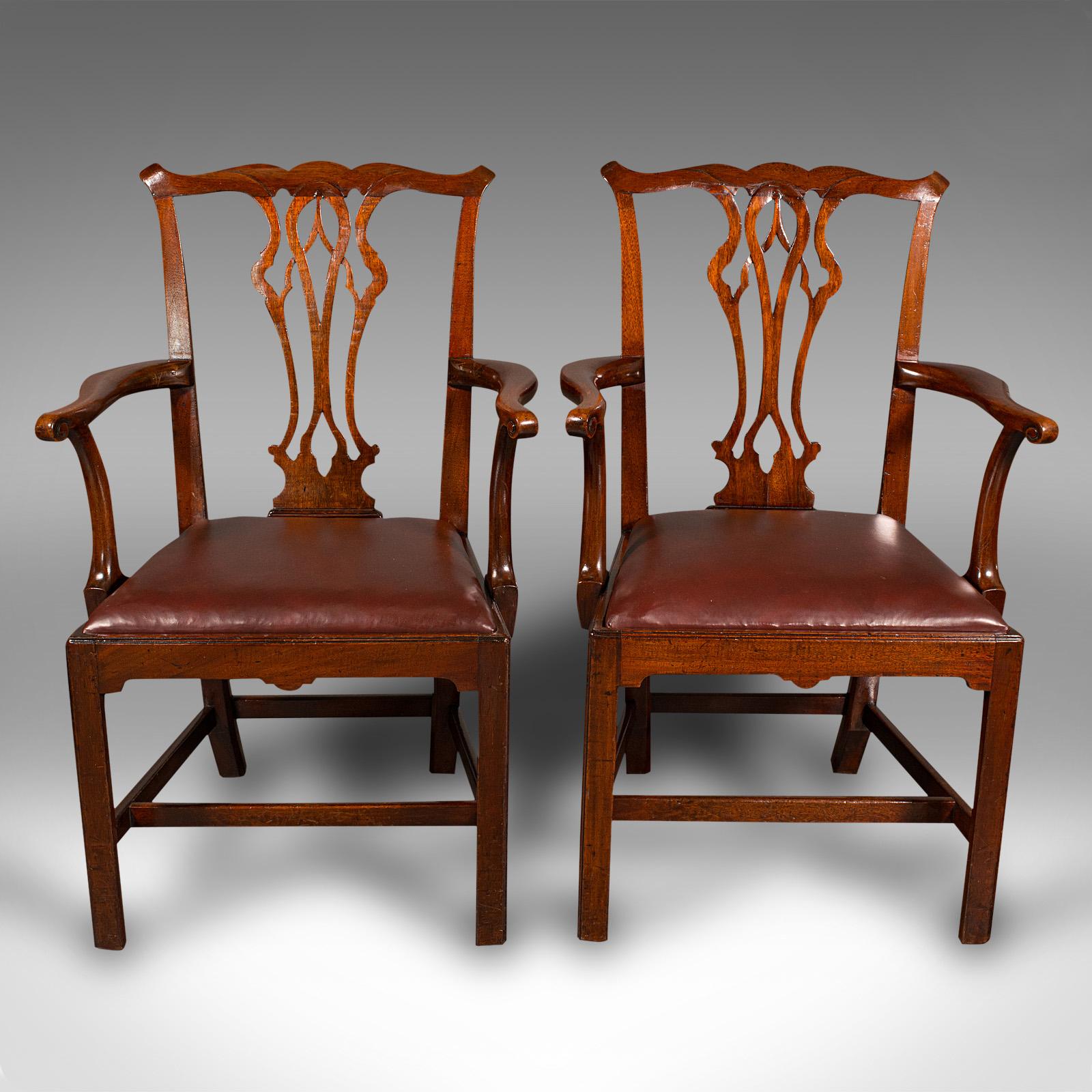 This is a pair of antique carver chairs. An English, mahogany and leather elbow seat in the Chippendale manner, dating to the Georgian period, circa 1800.

Superb Chippendale taste and fine craftsmanship
Displaying a desirable aged patina and in