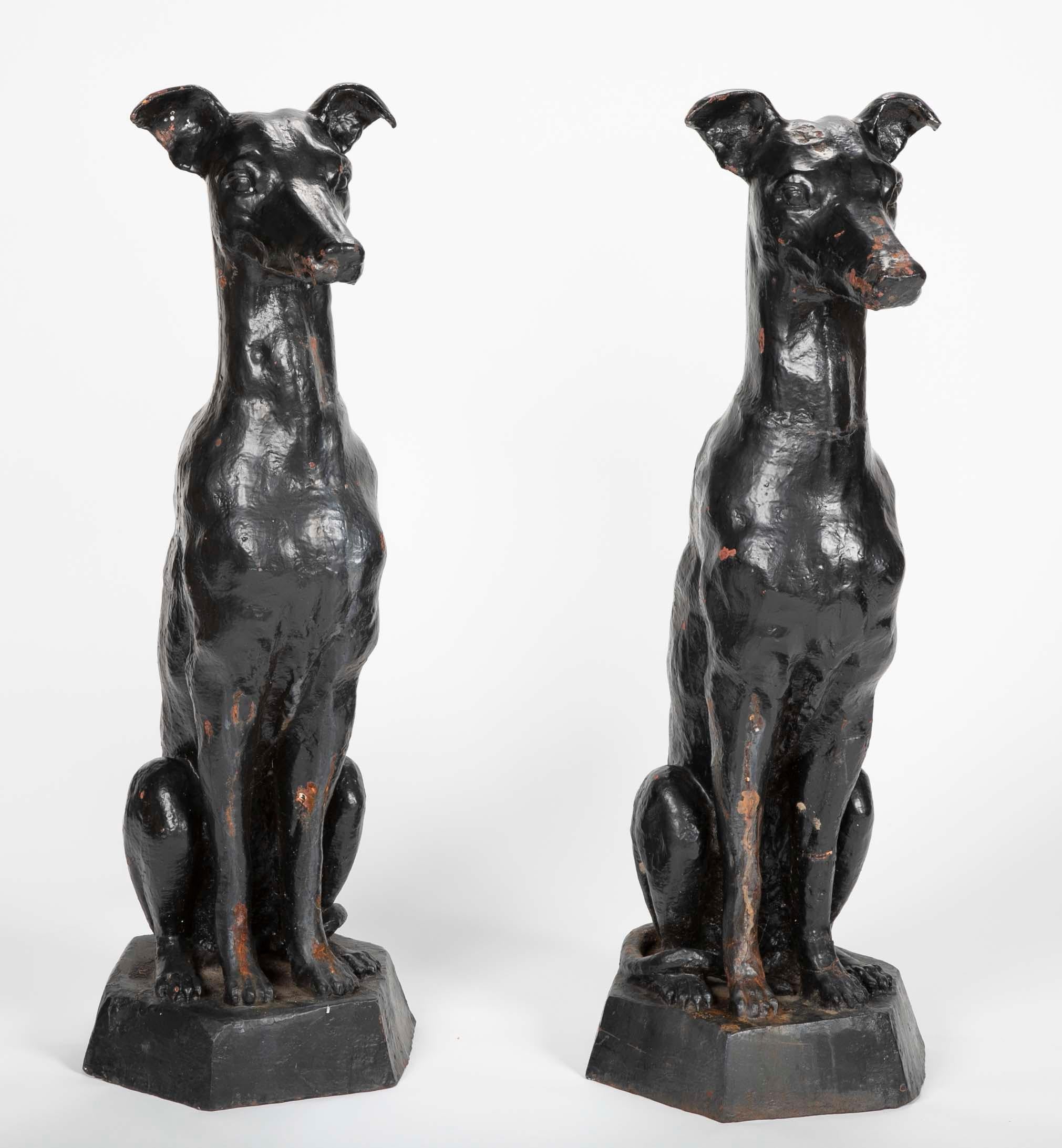 Pair of antique cast iron greyhound sculptures.
