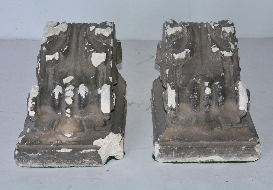 The pair of antique cast corbels are hollow and are secured with iron horizontal bars. Can be hung for display or use as brackets for shelving.  Also will work well for bookends.