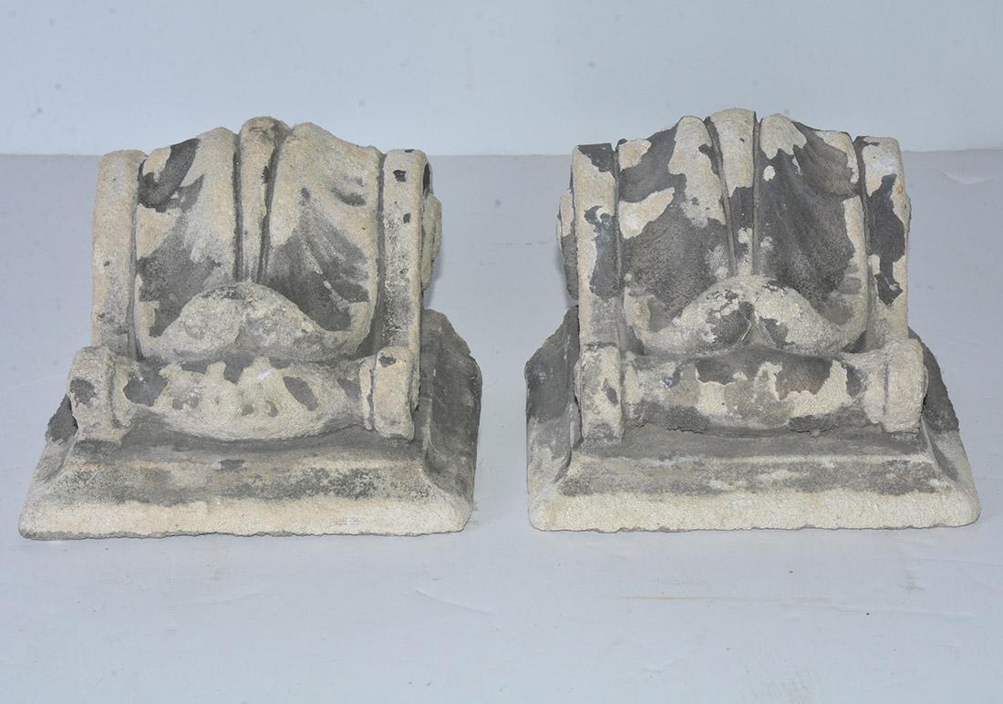 The pair of antique cast corbels are hollow and are secured with iron horizontal bars. Can be hung for display or use as brackets for shelving. Also will work well for bookends.