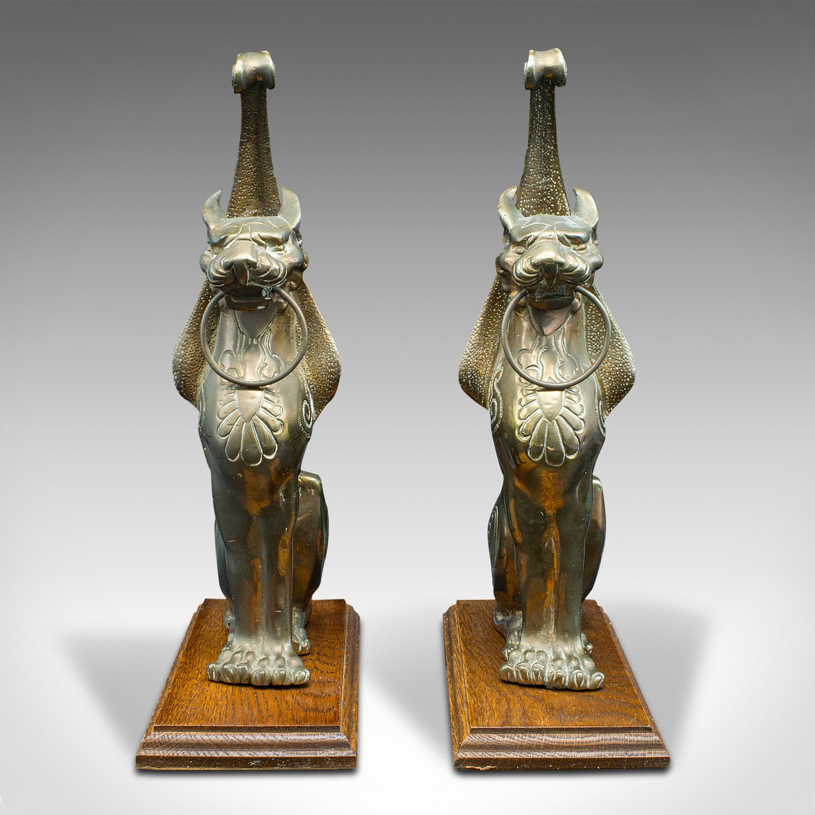 This is a pair of antique winged cat statues. An Italian, bronze on oak decorative figure in the Grand Tour taste, dating to the early Victorian period, circa 1850.

Striking cat ornaments with mythological wings
Displaying a desirable aged patina