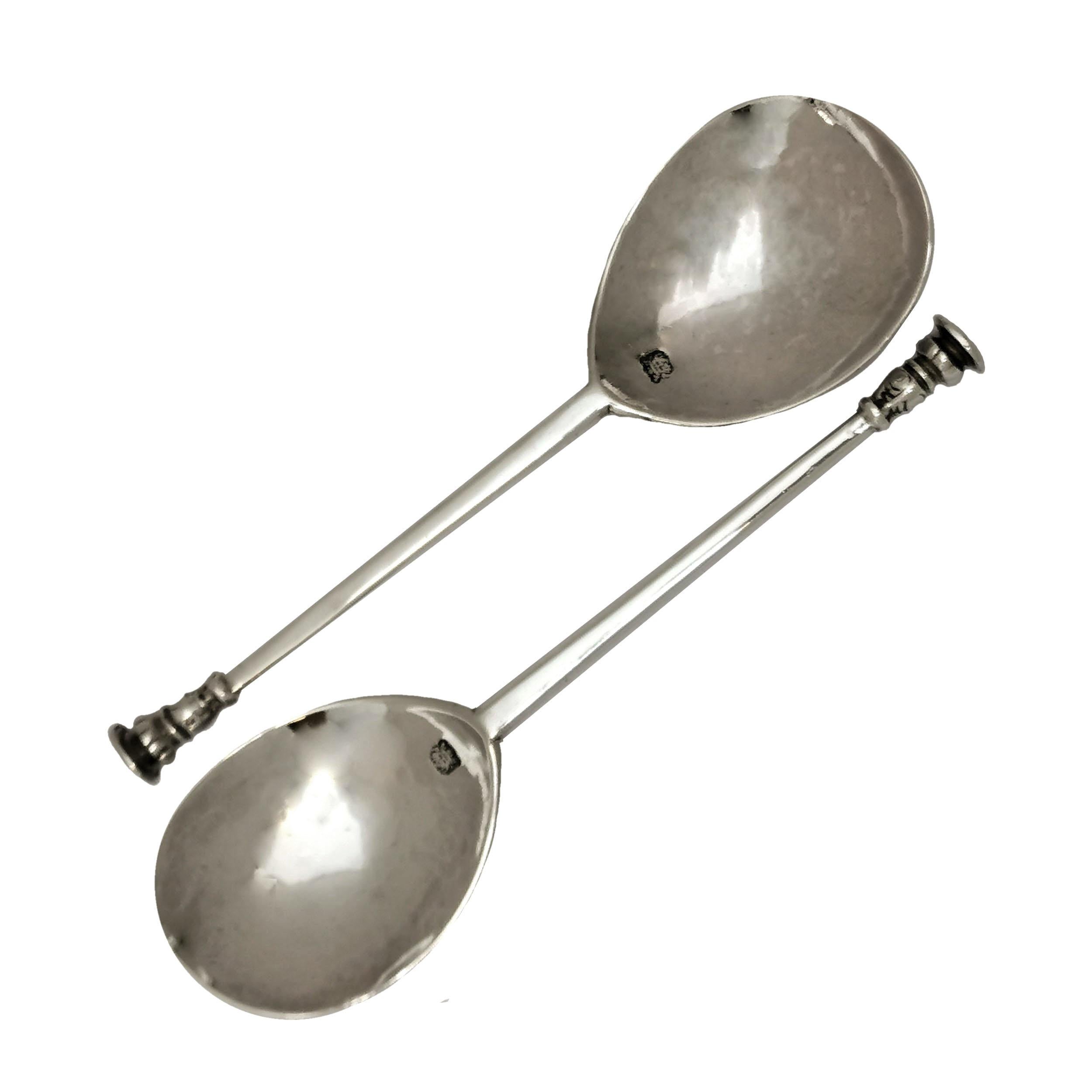 A Pair of classic antique Charles I sterling Silver Seal Topped Spoons with fig shaped bowls and subtly tapered hexagonal handle with knopped seals on the ends. Each Spoon has the crowned leopard of London hallmark stamped in the bowl and the