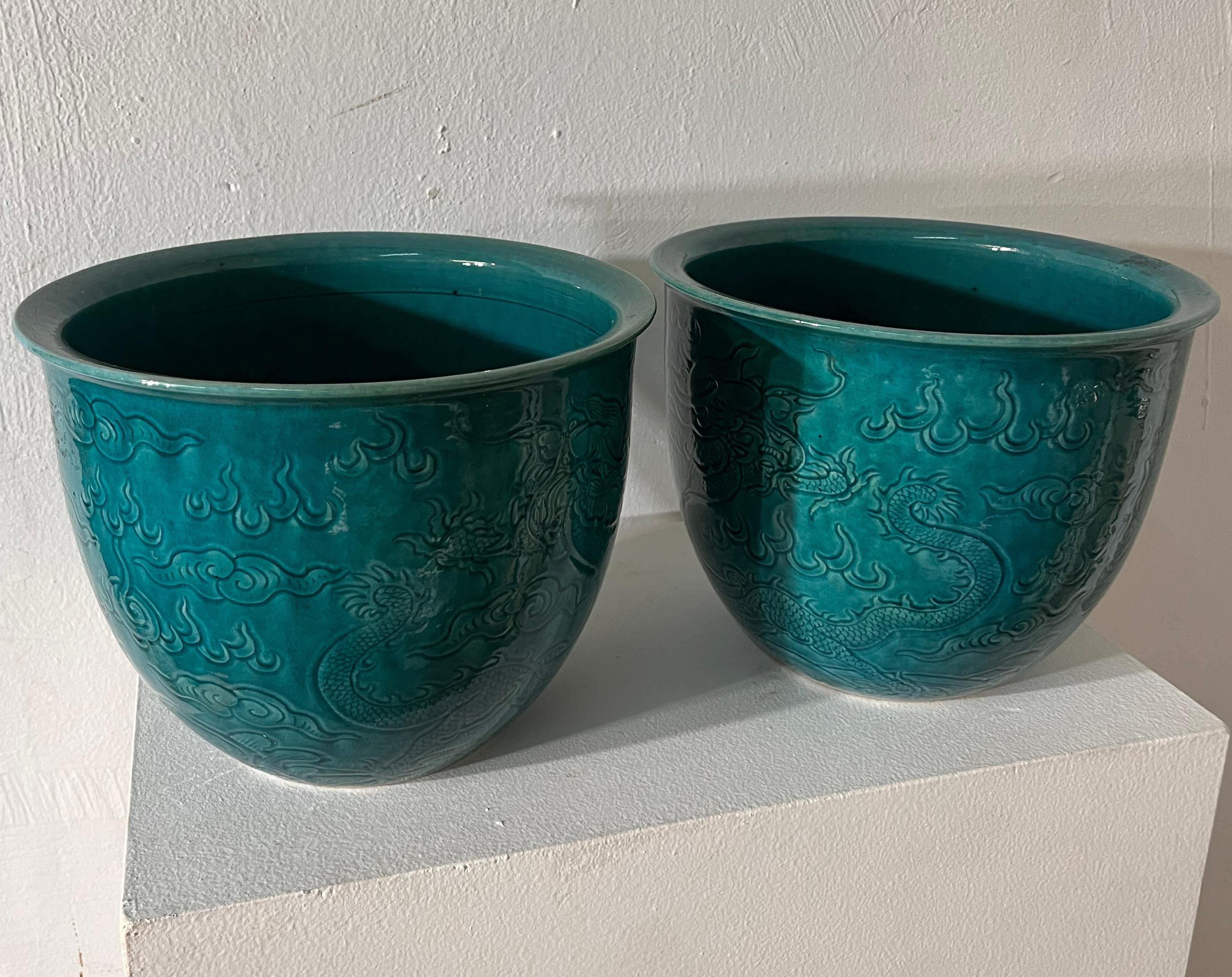 A turquoise glazed pair of jardiniere with incised five clawed dragons design,
China 19th century.
Small chips to the mouth rim.