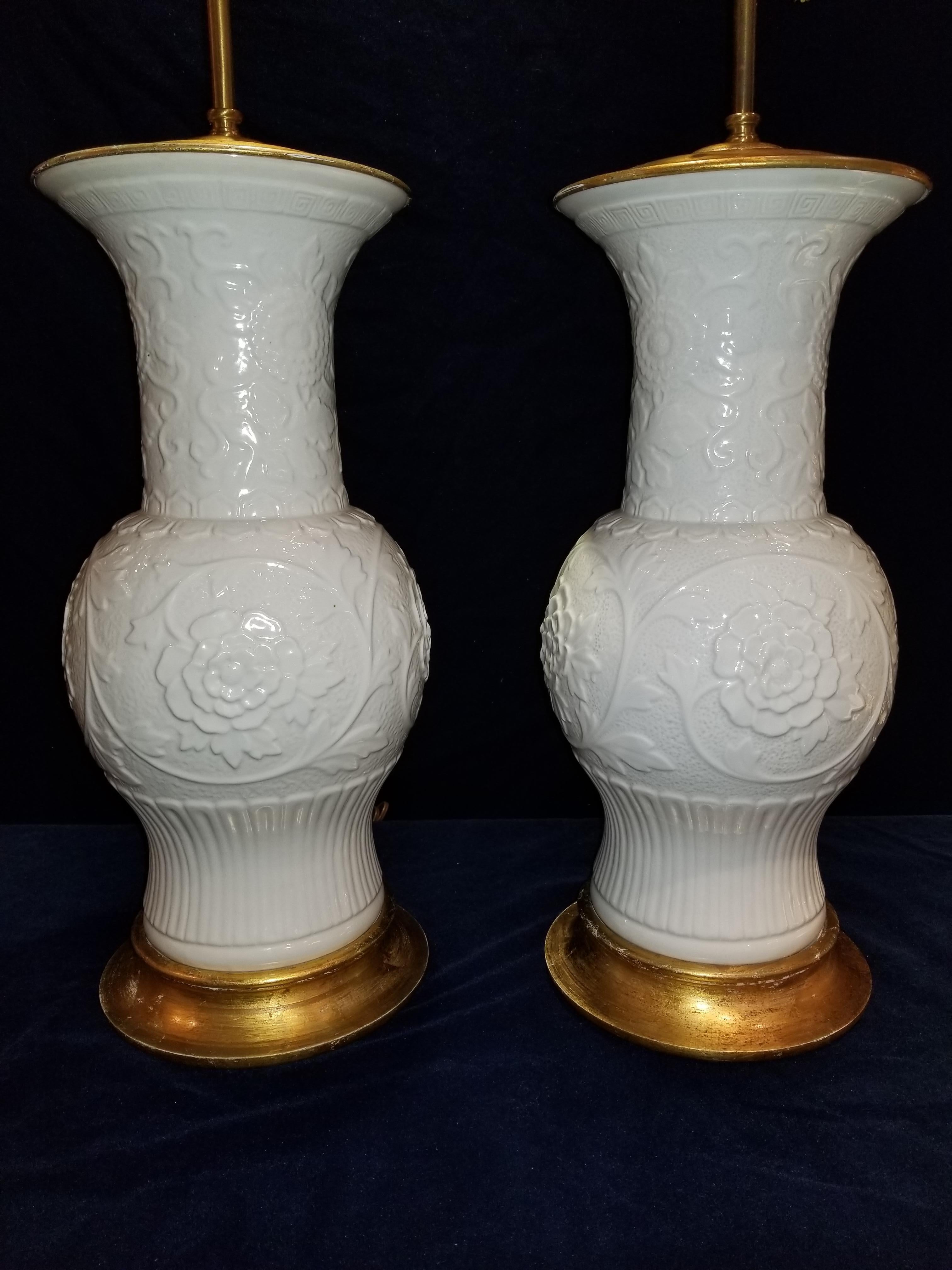 Il s'agit d'une paire de vases anciens en blanc de Chine montés comme lampes. Ils sont exceptionnellement fabriqués à la main et émaillés avec un savoir-faire exceptionnel. Le long de la base de chaque vase se trouvent des fleurs de roses