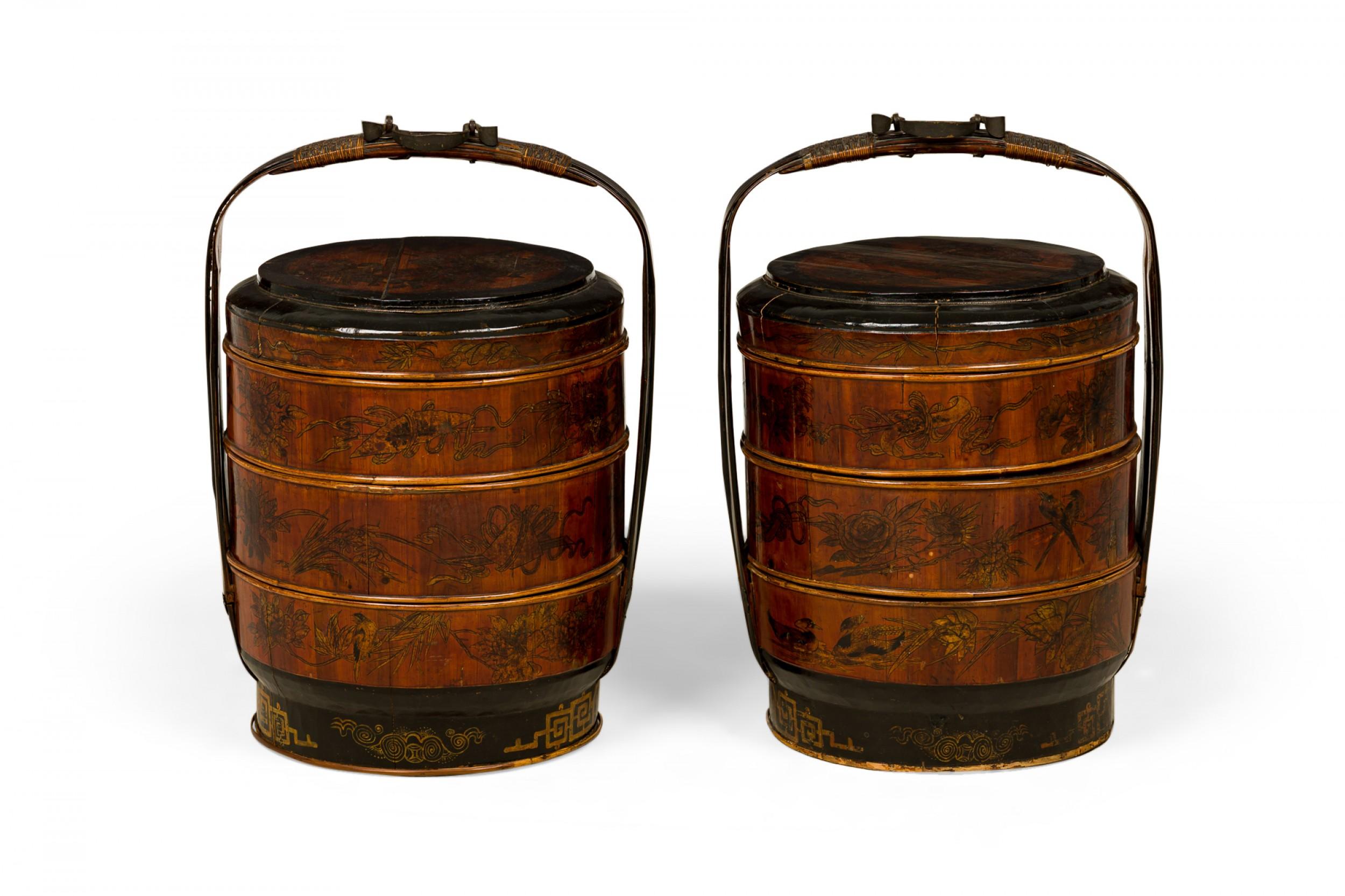 Pair of Antique Chinese wooden wedding baskets with lightly carved floral designs in horizontal bands along the exterior of three removable circular compartments, topped with a lid featuring a carved genre scene and mounted with carved wooden