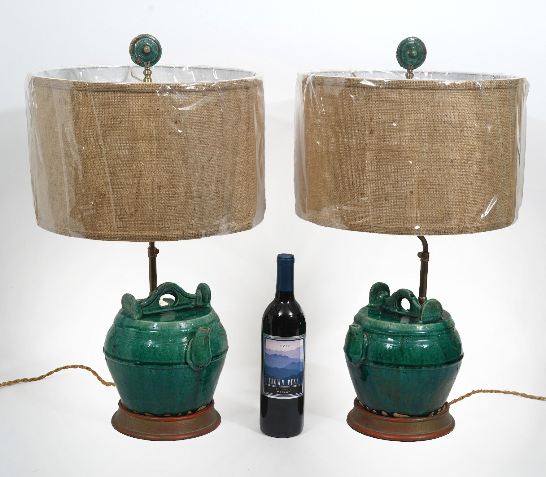 Antique Chinese ceramic jars mounted as table lamps. Recently new hardware and wired. Overall 27