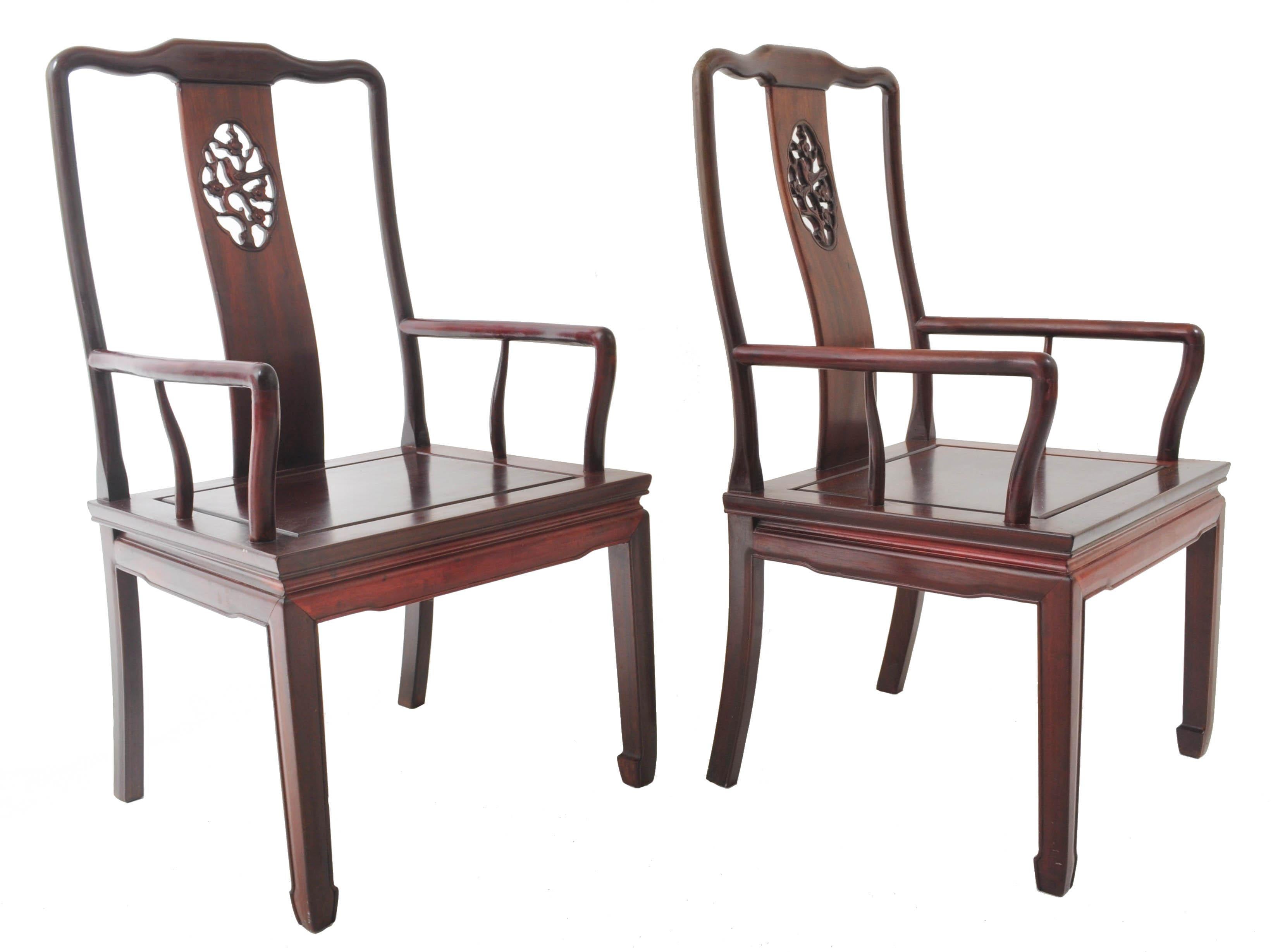 Pair of antique Chinese Chippendale rosewood armchairs, Qing Dynasty, circa 1900. The chairs having splat backs that are pierced and carved, the arms supported by a single rail. The chairs standing on shaped feet.