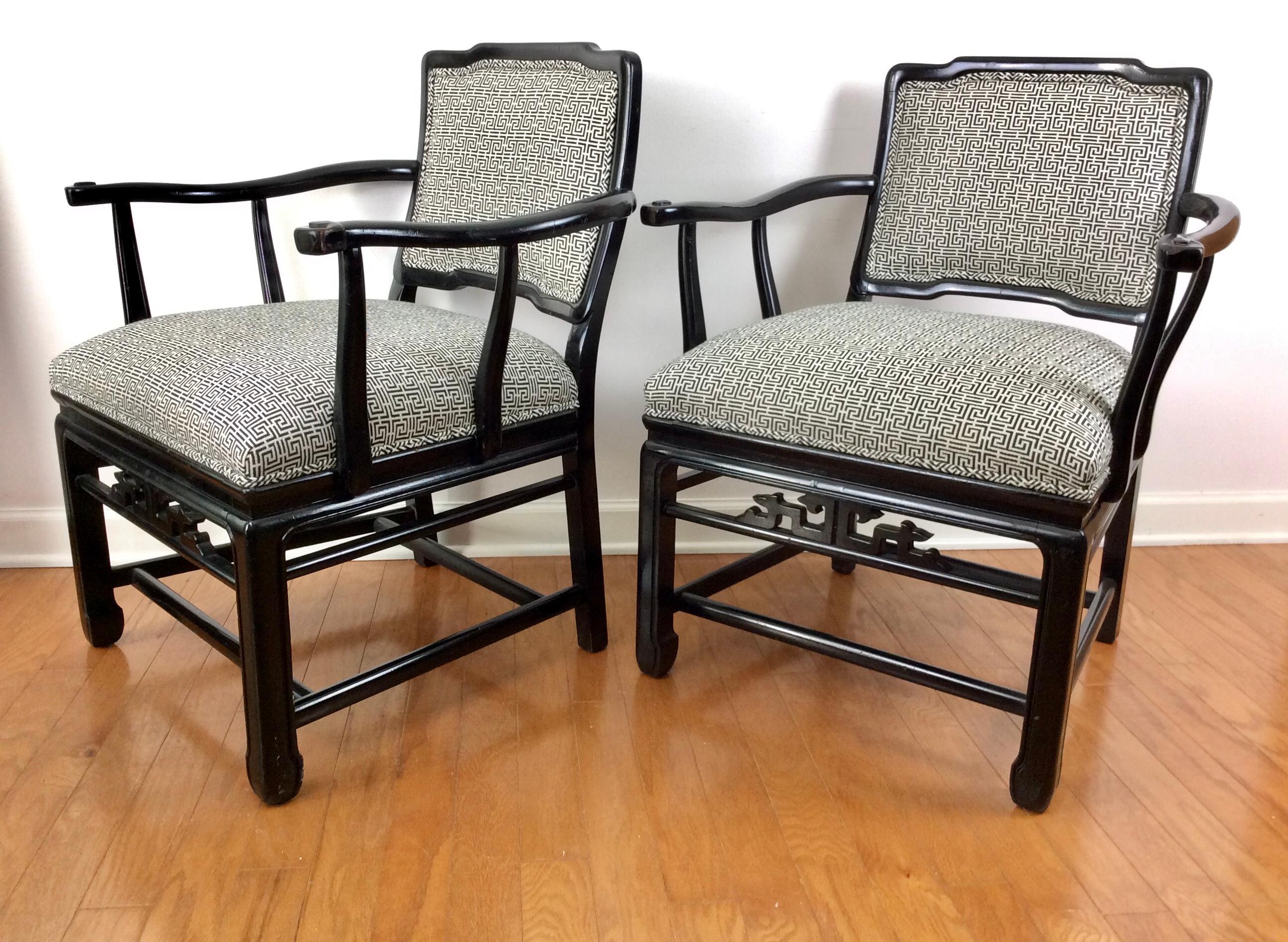 Pair of Chinese Elm Black Lacquered Chairs. Wide horseshoe frame design that is extremely comfortable. Newly reupholstered in a Chinese Double Happiness black and white fabric.

 Seat 19”H, 21”D, Interior Width 24”. Arm Height 27”
