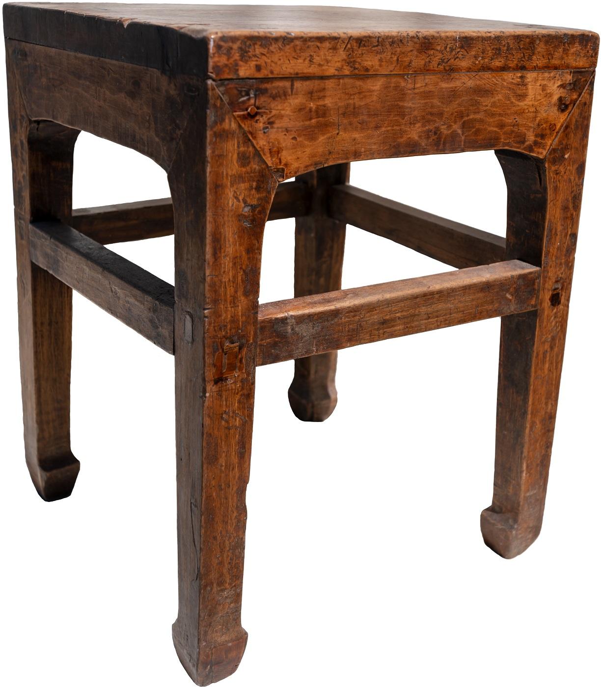 Pair of antique Chinese elmwood stools, 19th century.