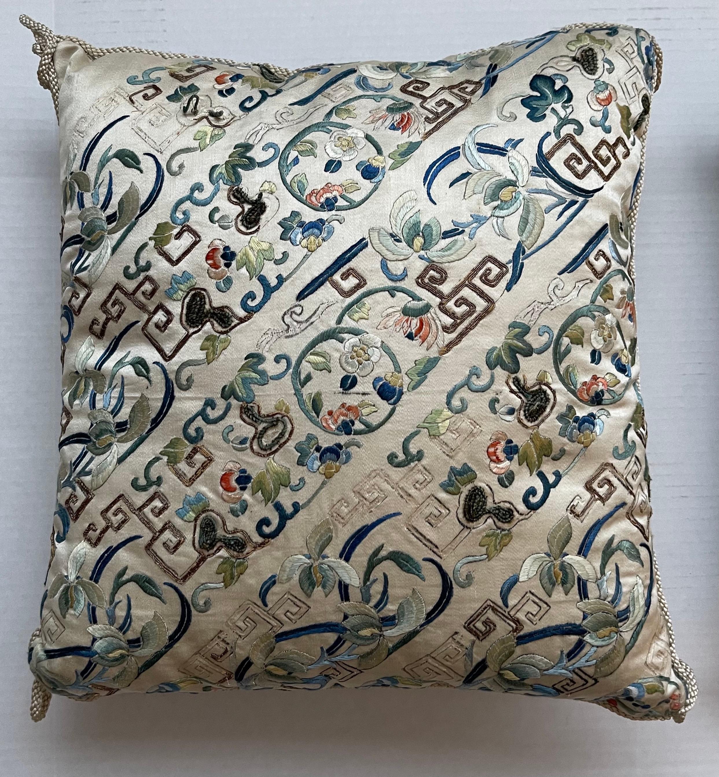 Pair of antique Chinese embroidered silk textiles made into custom pillows. Pale oyster grey silk with all over embroidery with gold couching (threading). Backed in coordinating silk fabric.