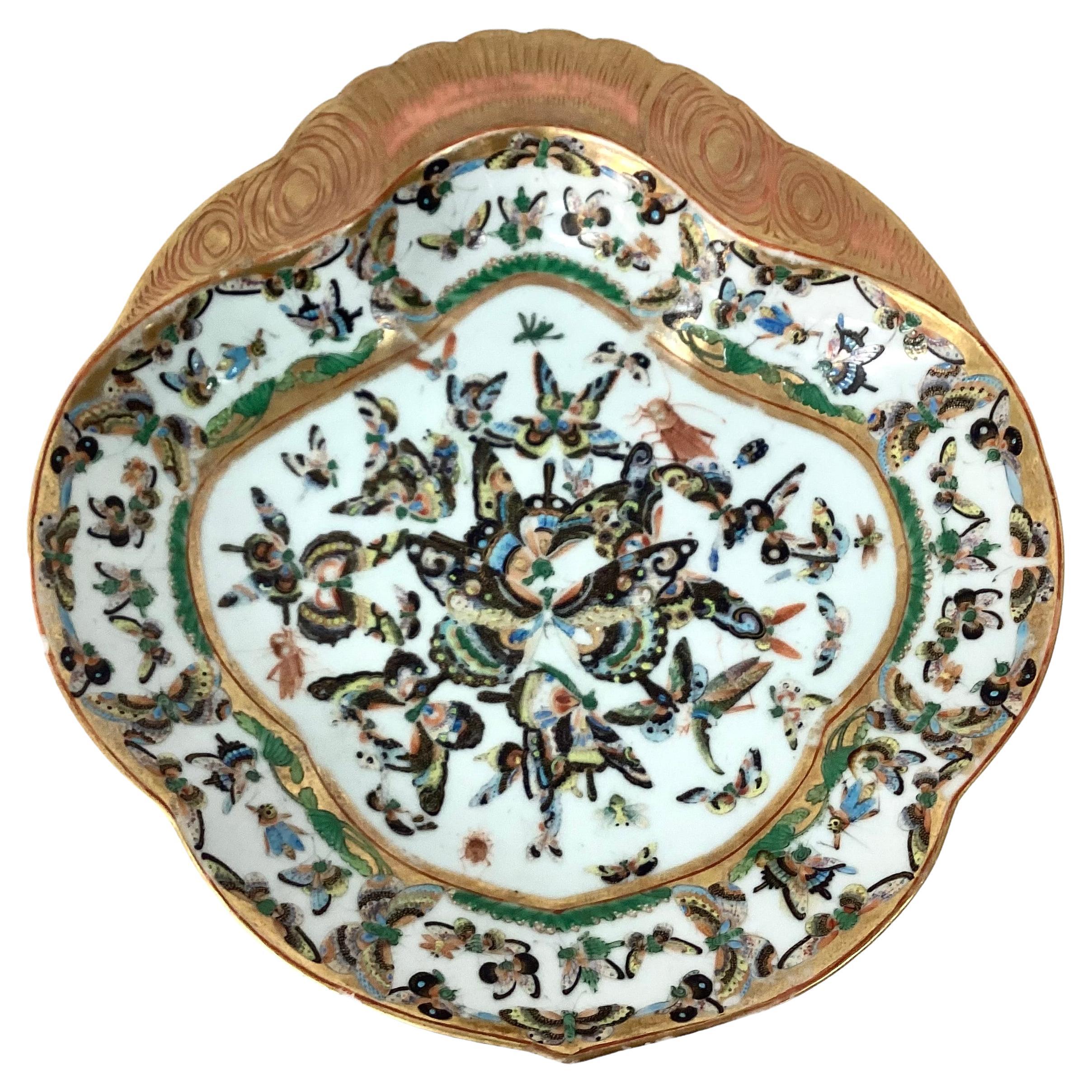 Rare pair of antique Chinese export porcelain butterfly serving/shrimp dish. Unique pair of dishes that include large gilt rim and trim on plates decorated with butterflies in green, black, yellow and gold colors. 