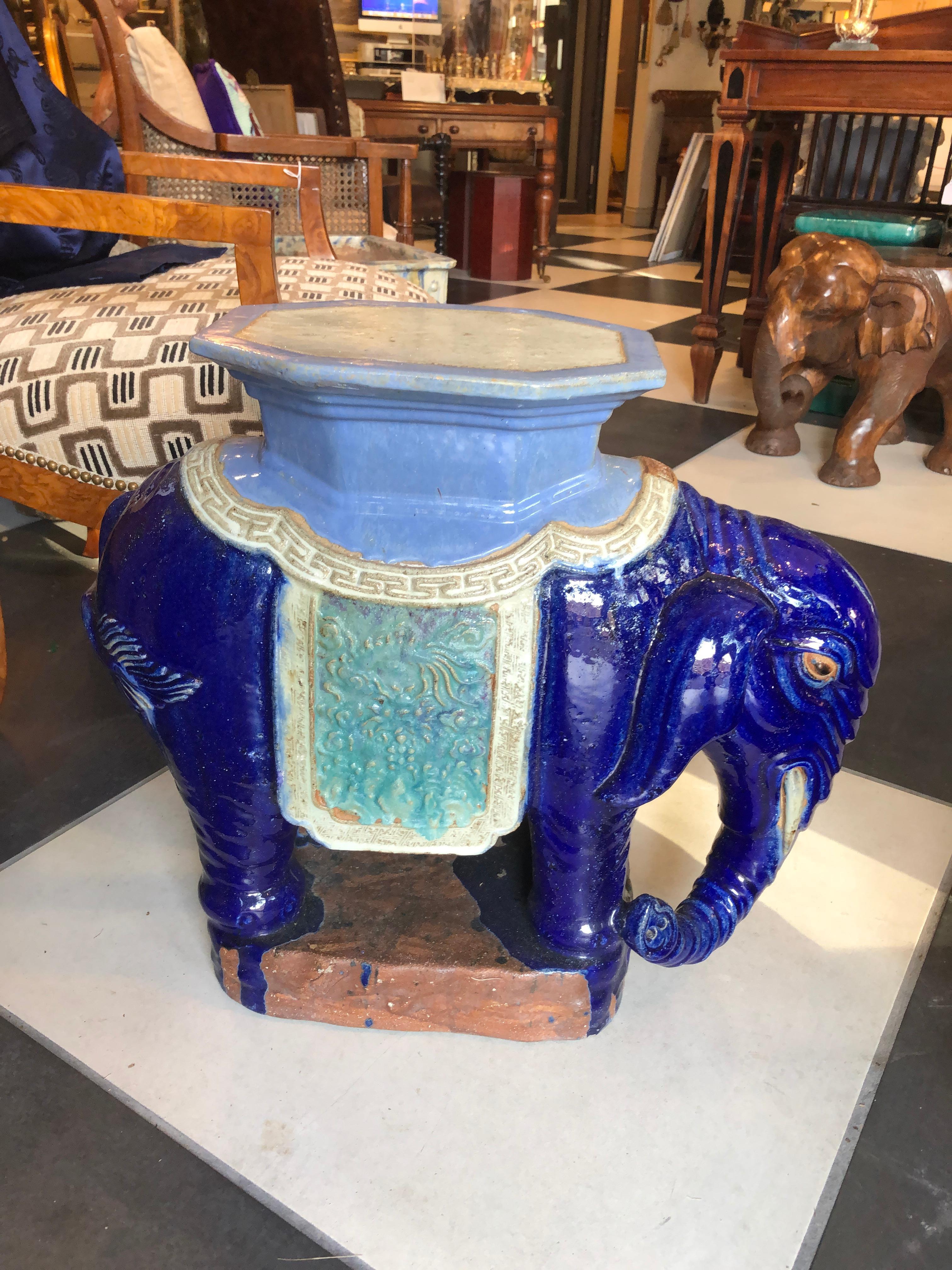 A pair of Chinese garden elephant stands/side tables hand painted in mid-night blue, leaded glaze which gives it a more luxurious look. These ceramic elephants would make a plus addition to a living room, patio or garden. Elephants are designed on