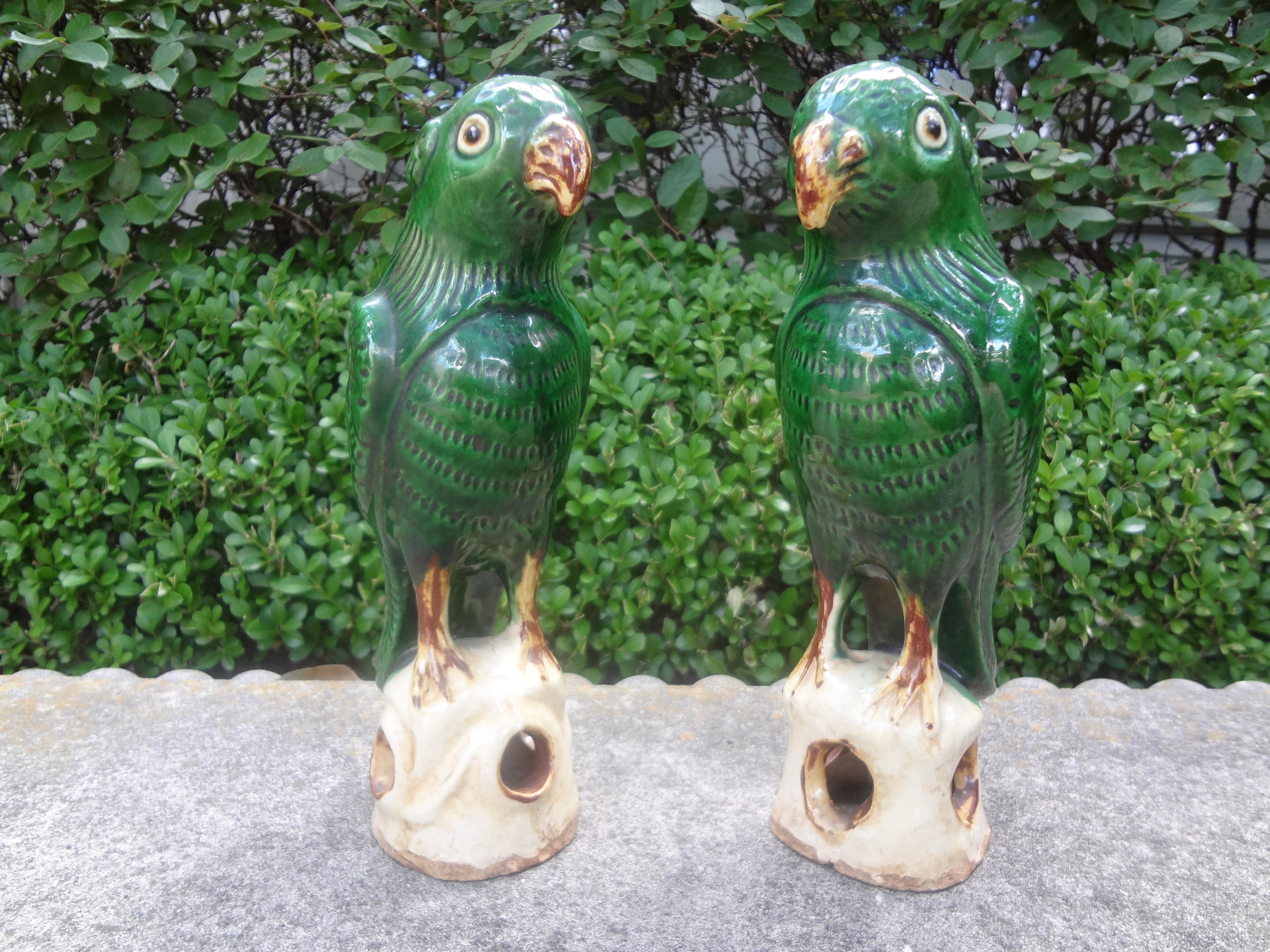 Great pair of Chinese export glazed pottery or clay birds or parrots, circa. 1900. This charming pair of Chinese parrot figures are heavy, well made and executed in a beautiful shade of green. Our parrots are in great condition and would make a