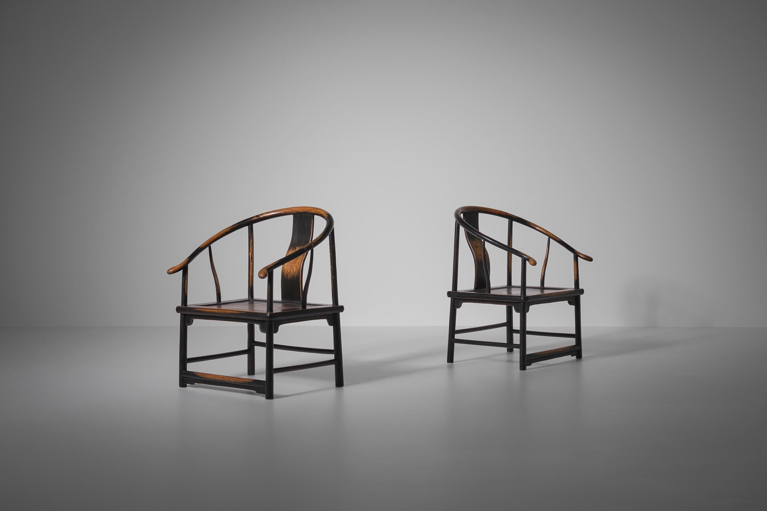 Pair of Antique Chinese chairs, early 20th century. These Chinese horse shoe chairs are made from Northern Elm (yumu) from Northern China with a beautiful patina. These chairs received their name due to their name because of the continuous curved