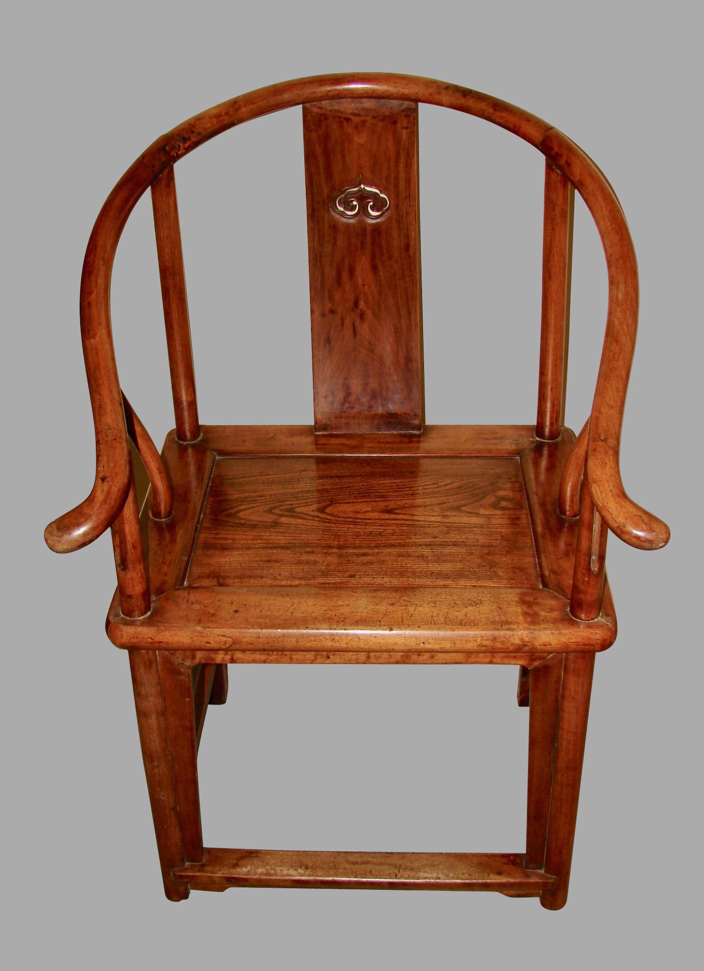 A pair of Chinese hardwood horseshoe back armchairs, each curved back with downswept arms and outswept hand grips, centring an elegant shaped pierced splat, flanked by cylindrical stiles continuing to undulating arm supports. The rectangular seat